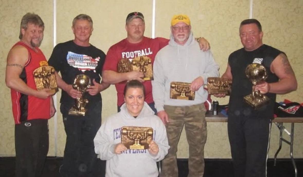 A group of people holding trophies