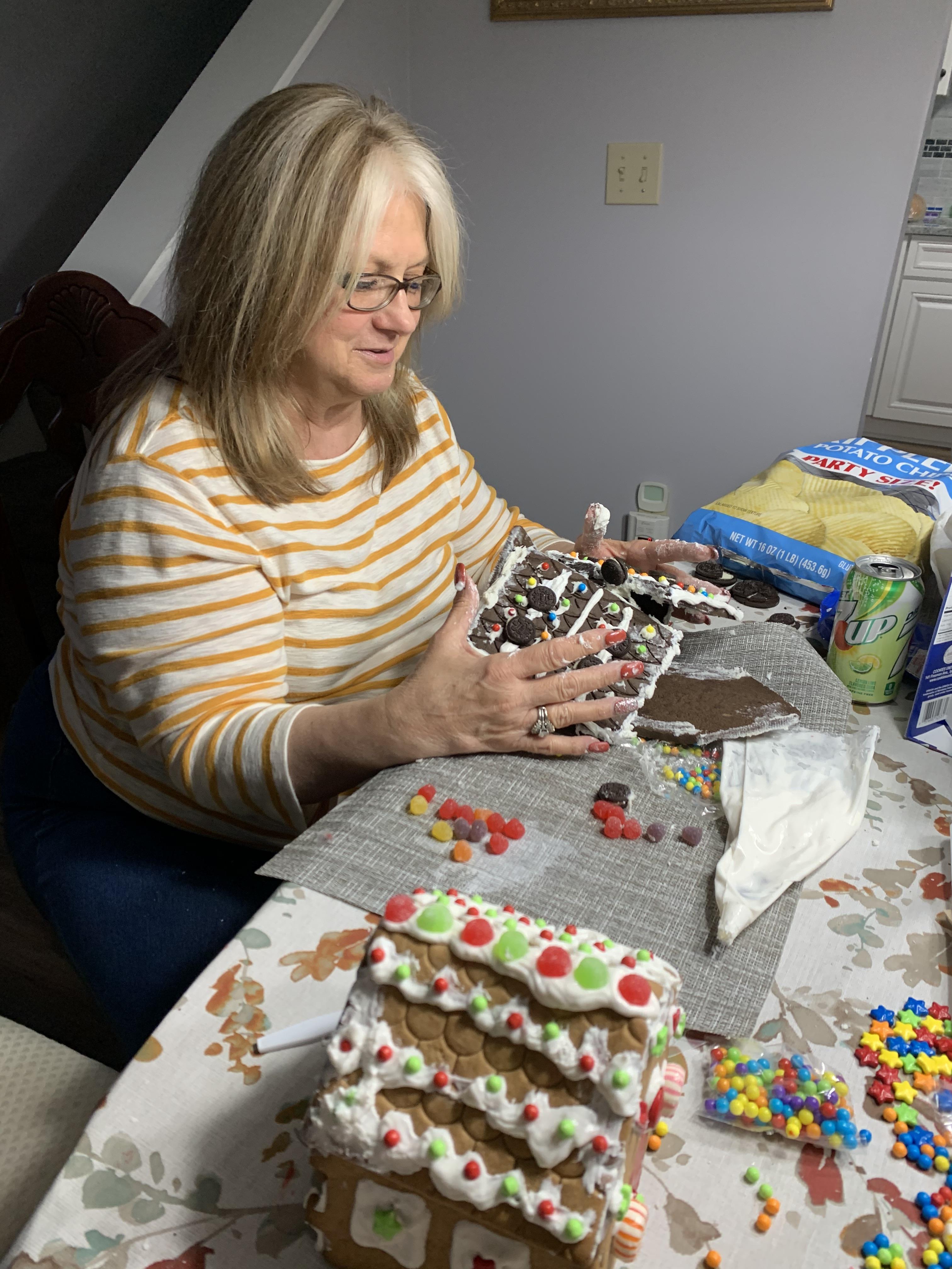 A woman making a gingerbread house