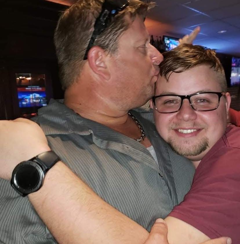 A man kissing another man