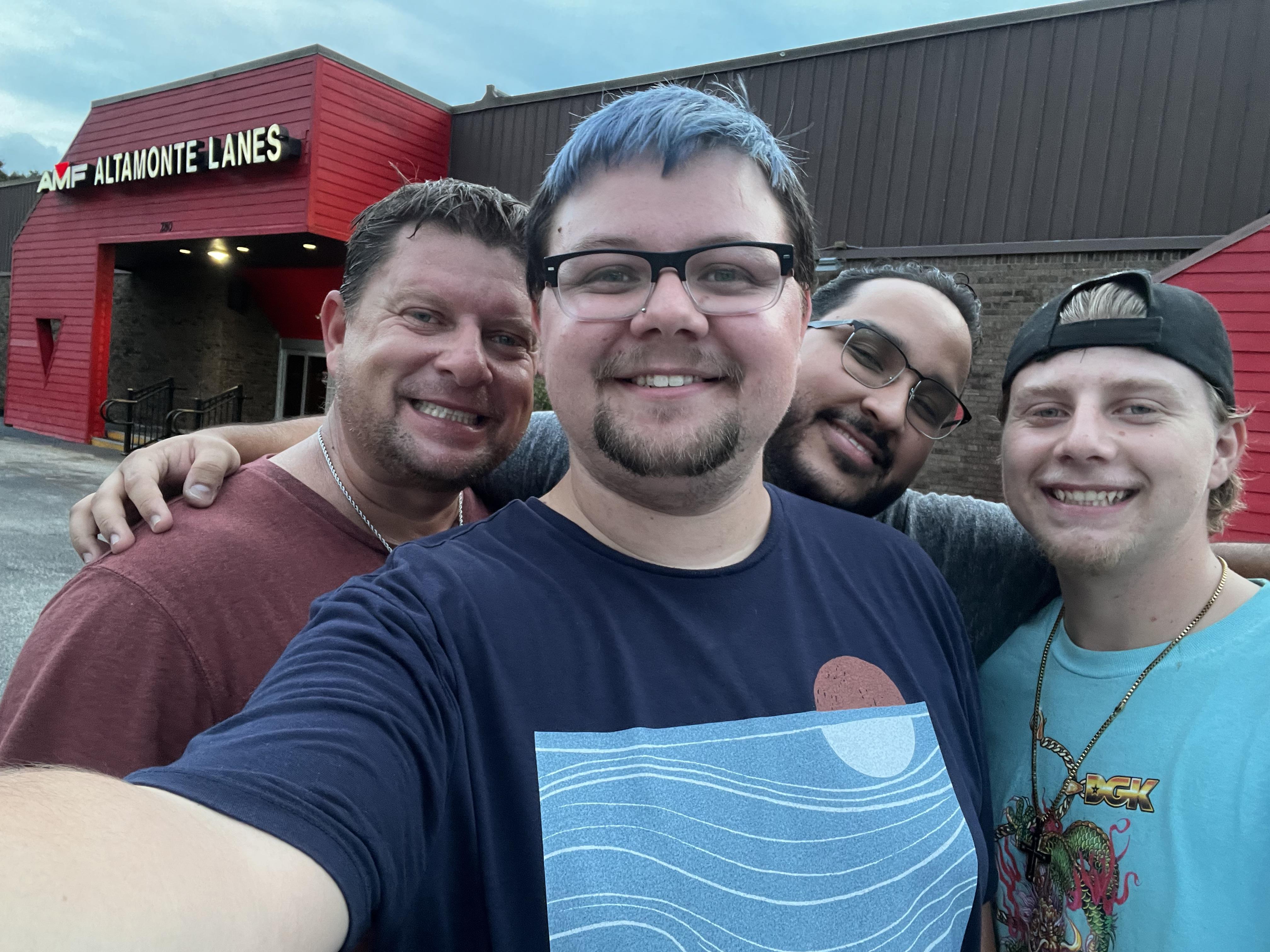 A group of men posing for a selfie