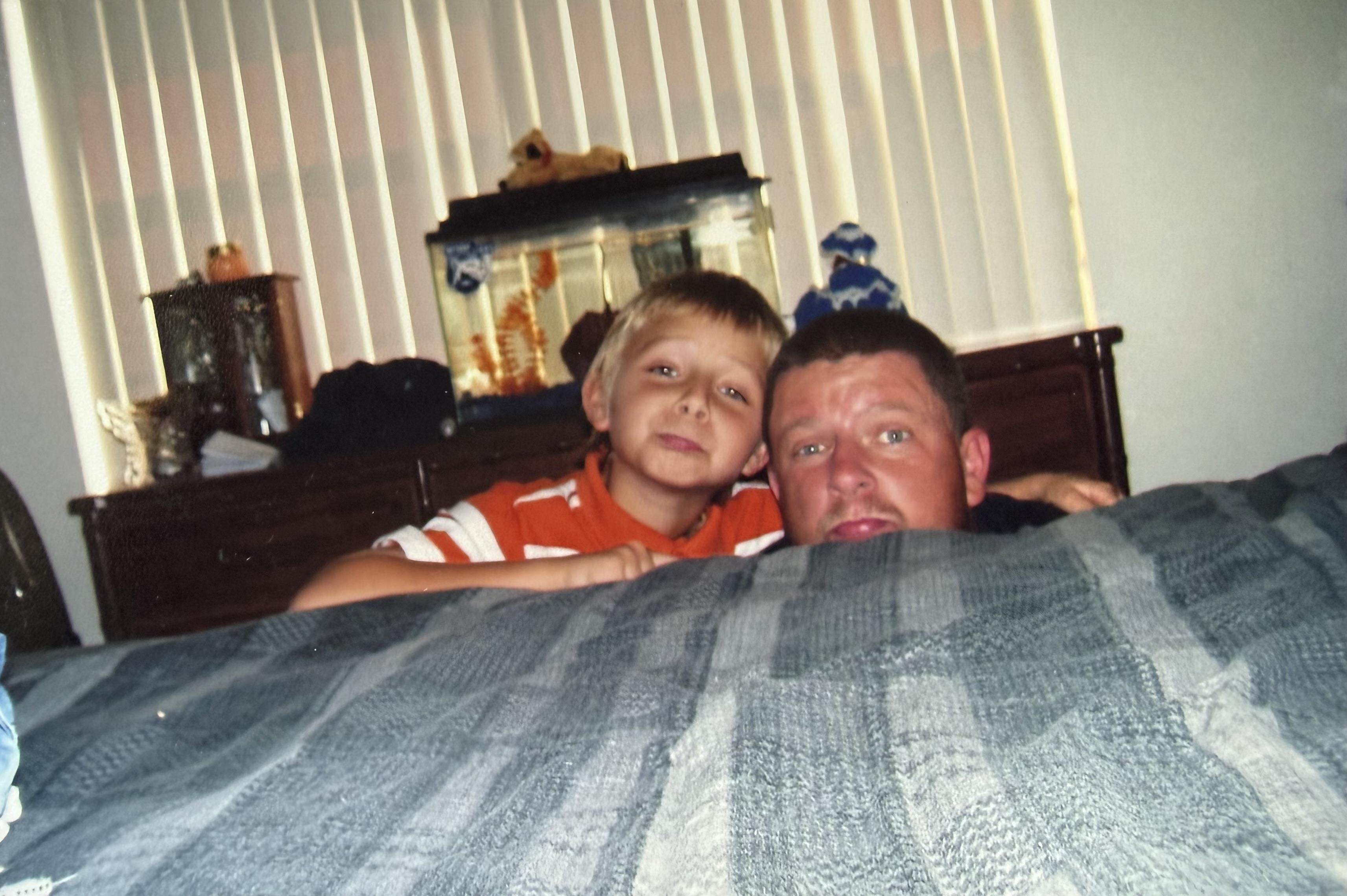 A man and boy posing for a picture