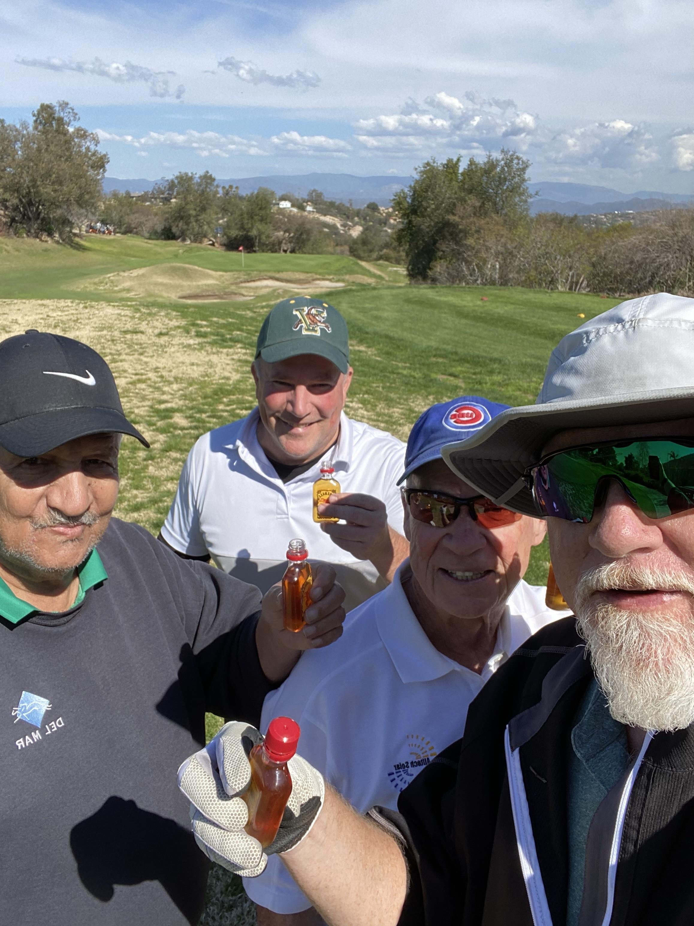 A group of men standing on a golf course