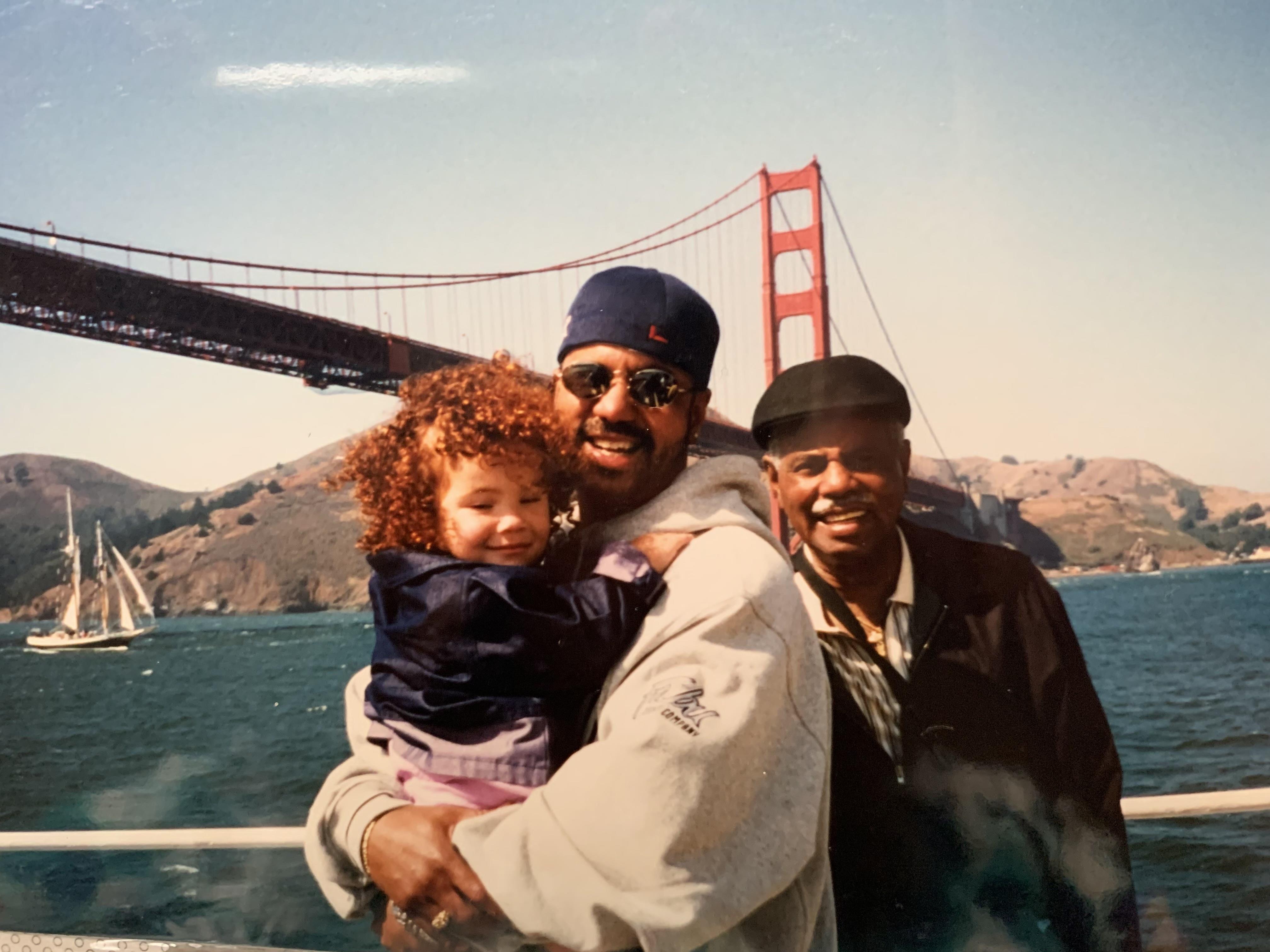 A group of people on a boat with a bridge in the background