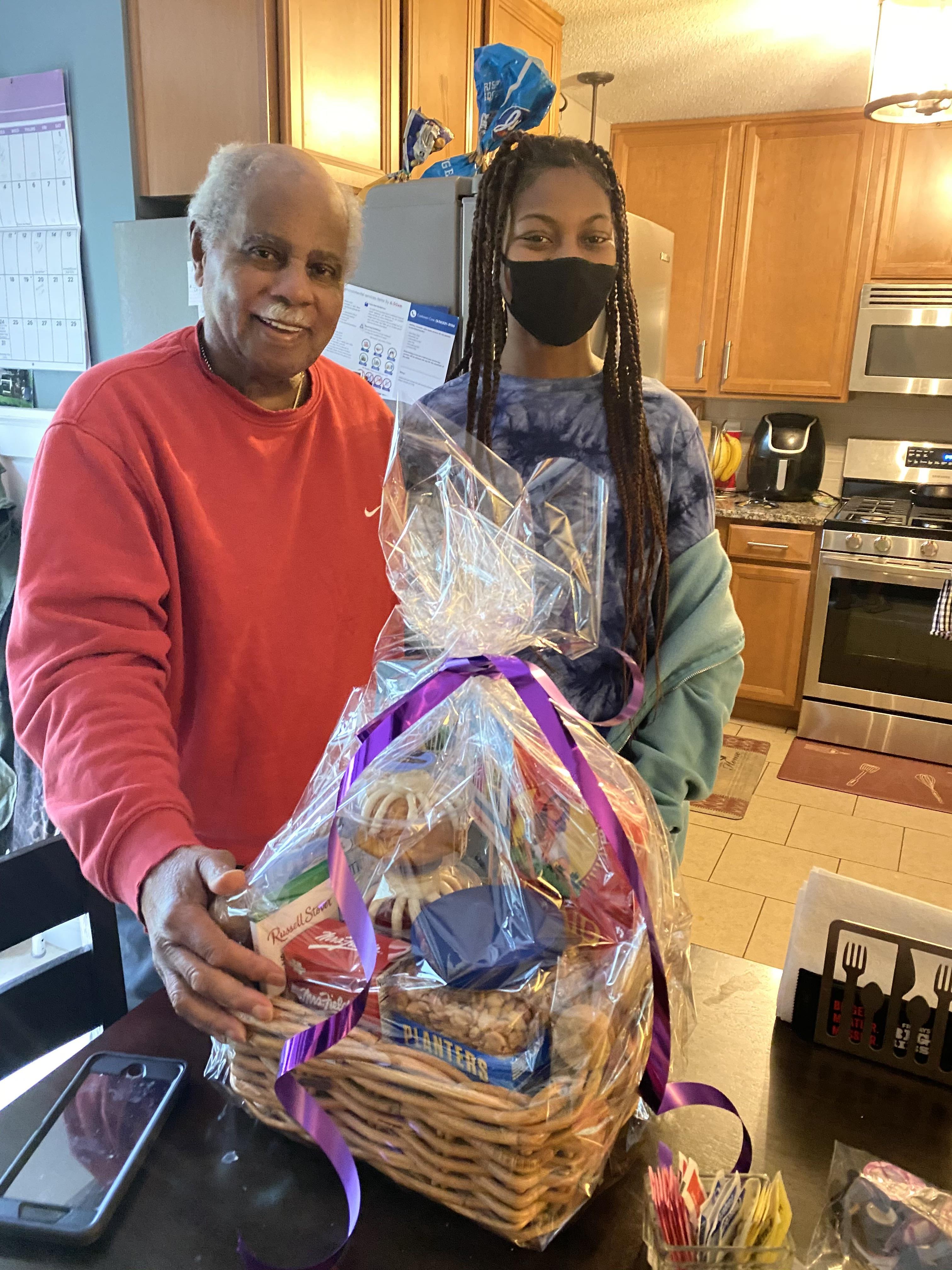 A woman and a man holding a gift