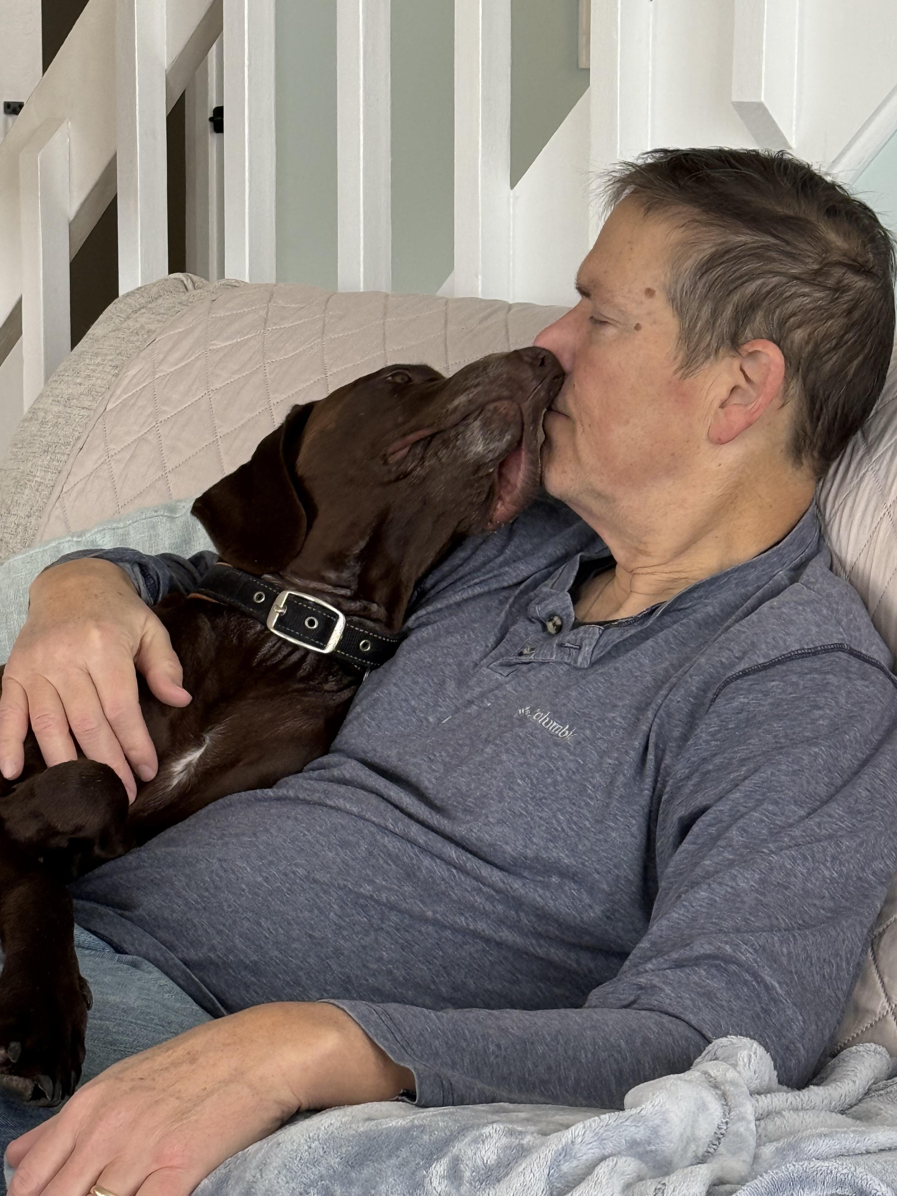 A man and dog on a couch