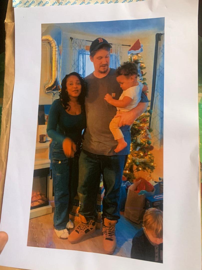 A man and woman holding a baby