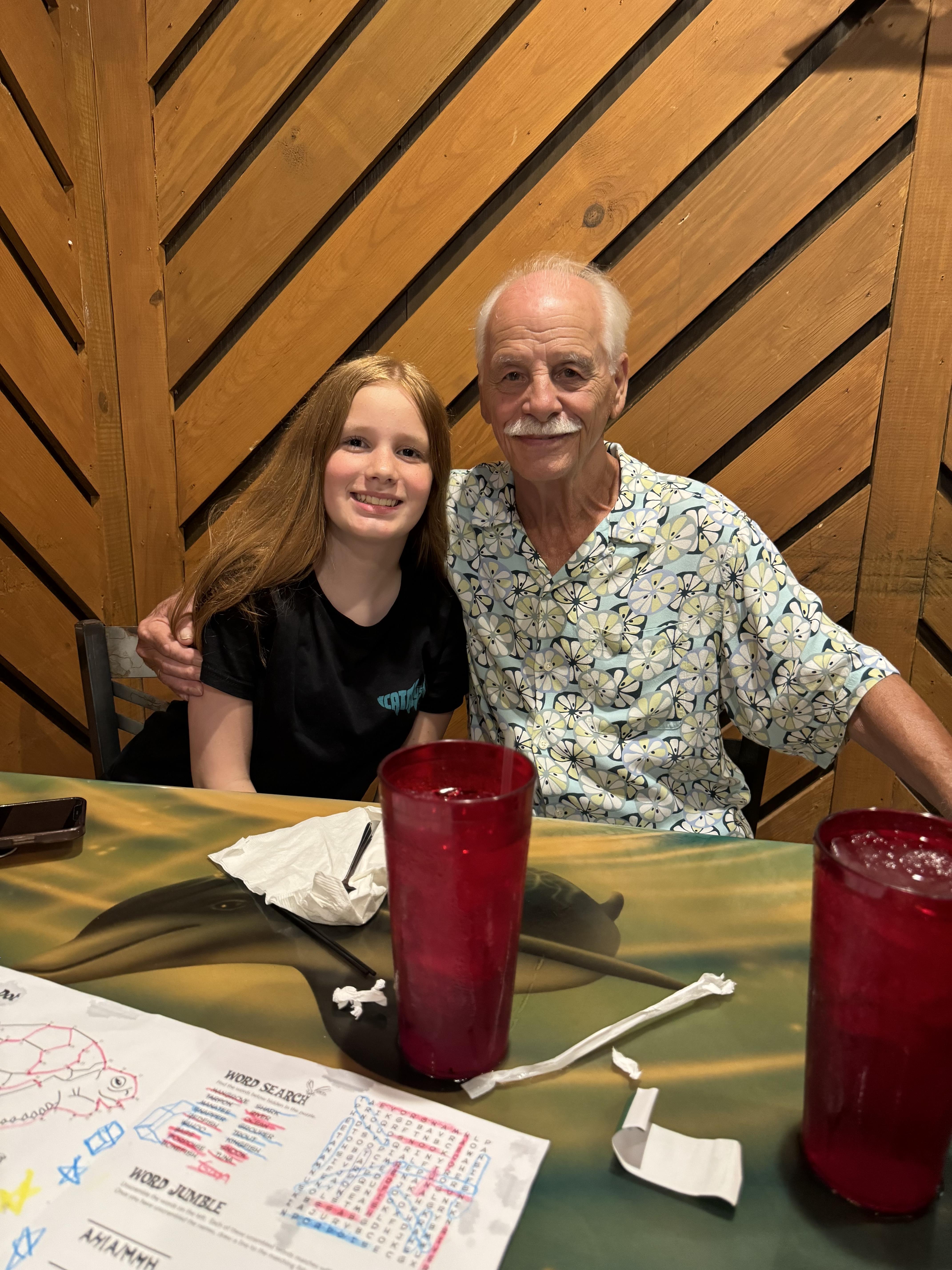A man and girl sitting at a table
