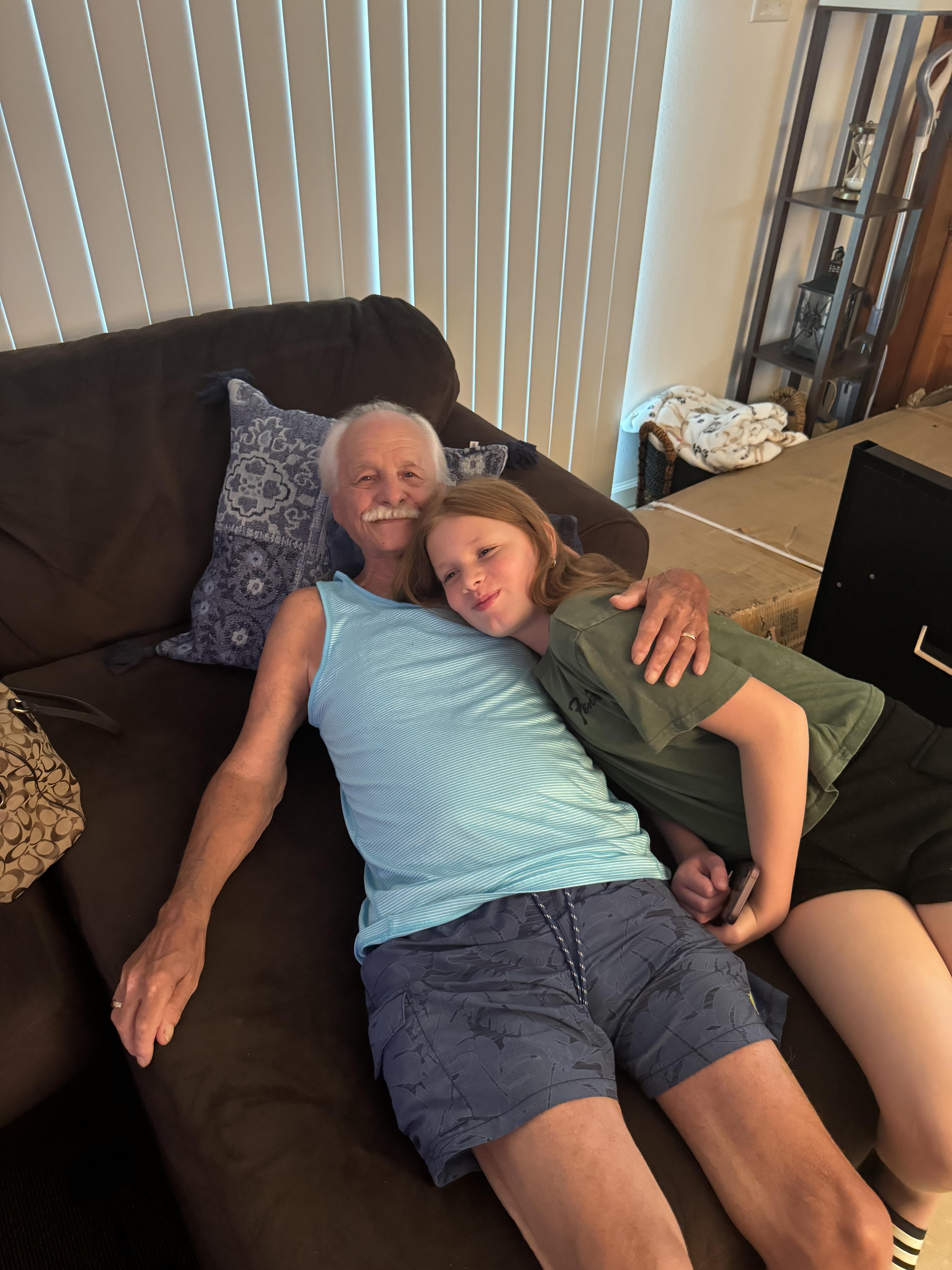A man and girl lying on a couch
