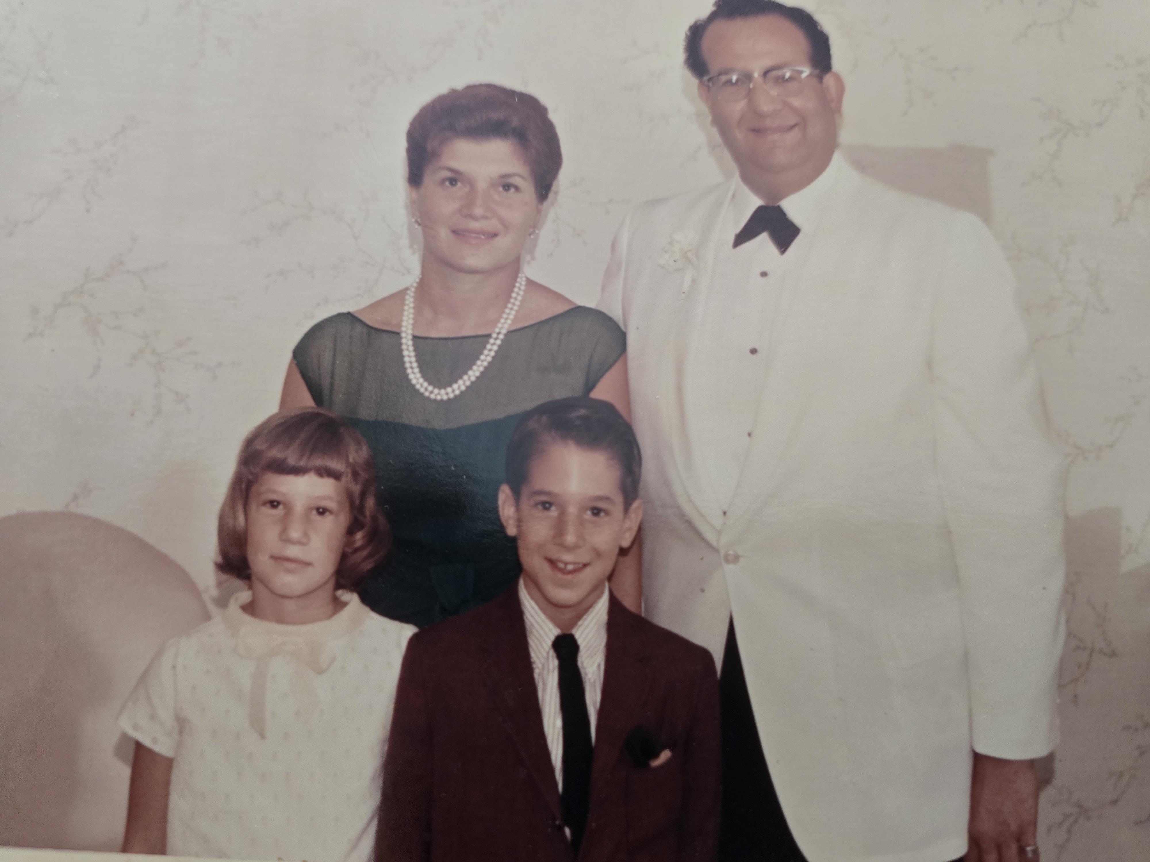 A family photo of a man and woman and two children