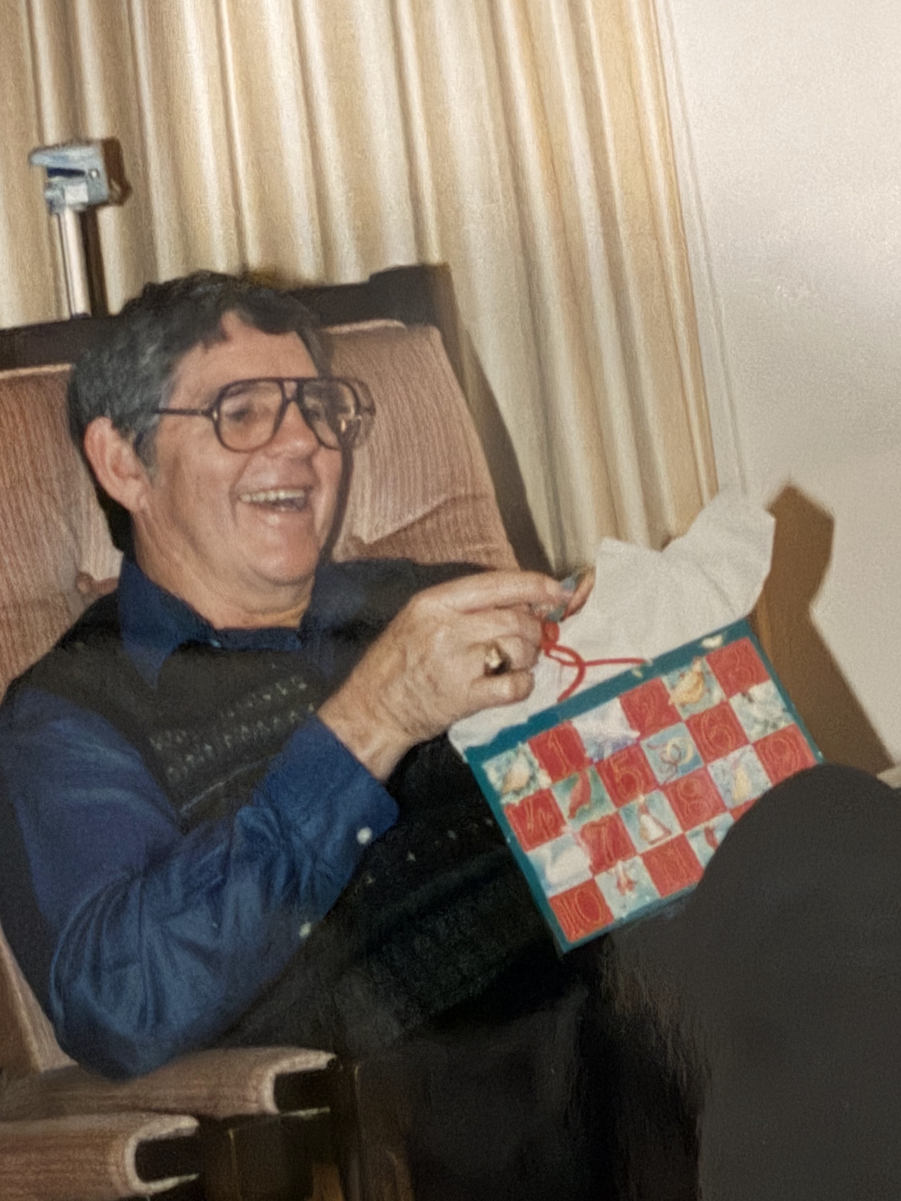 A man sitting in a chair with a bag