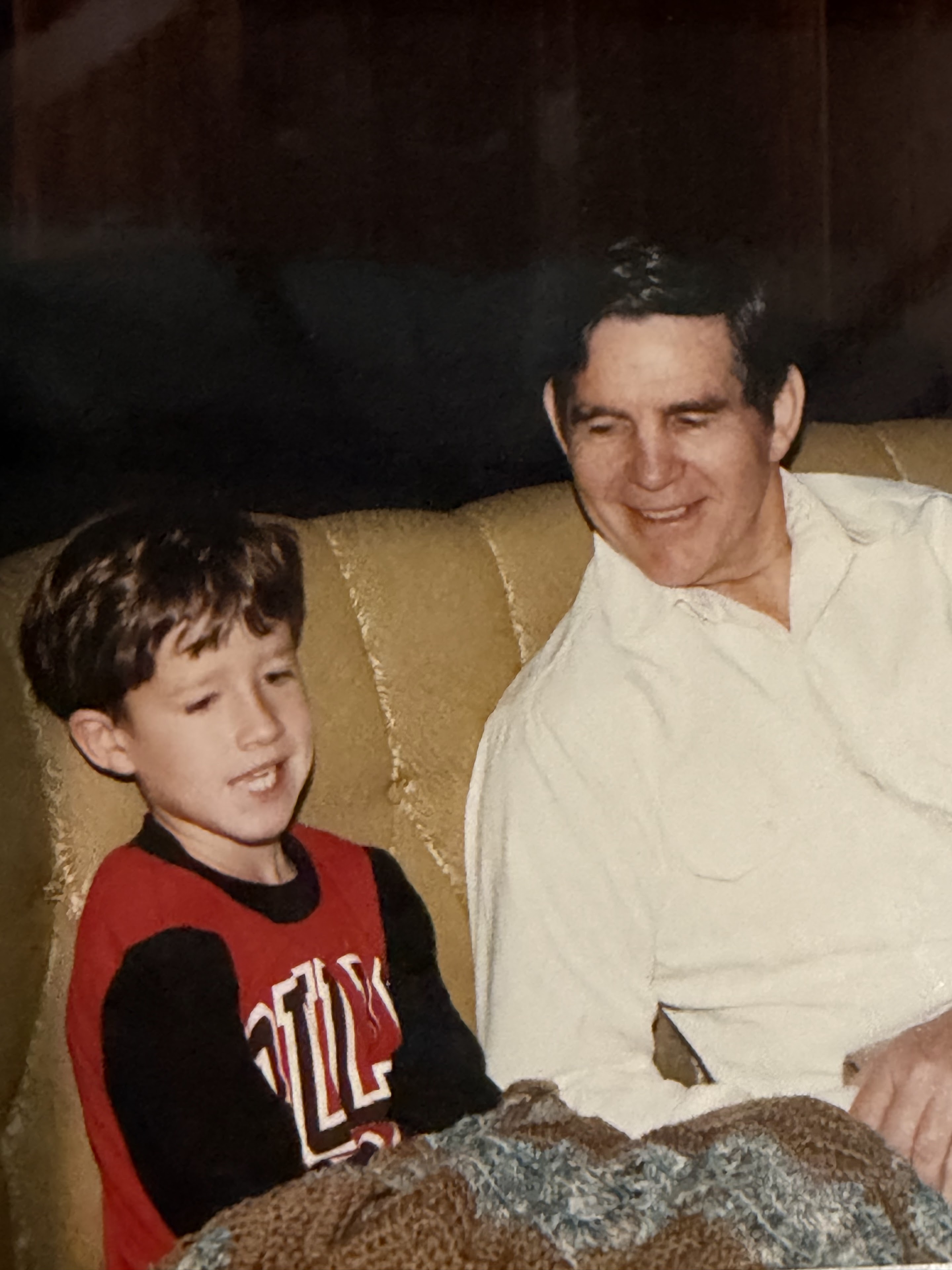 A man and boy sitting on a couch