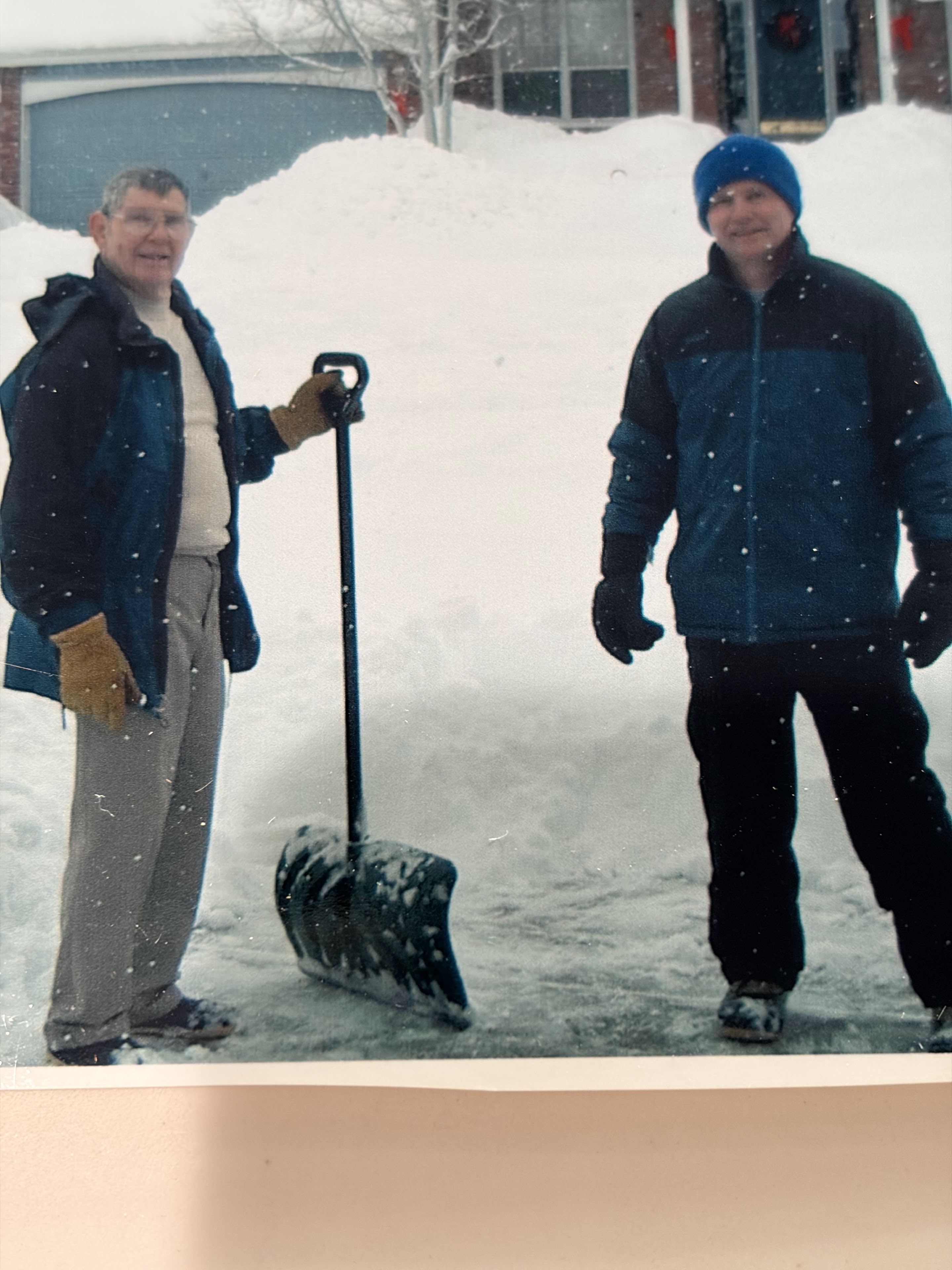 Two men standing in the snow