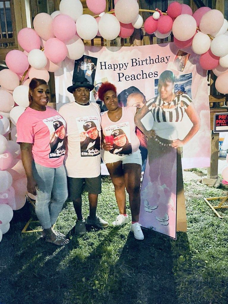 A group of people standing in front of a sign