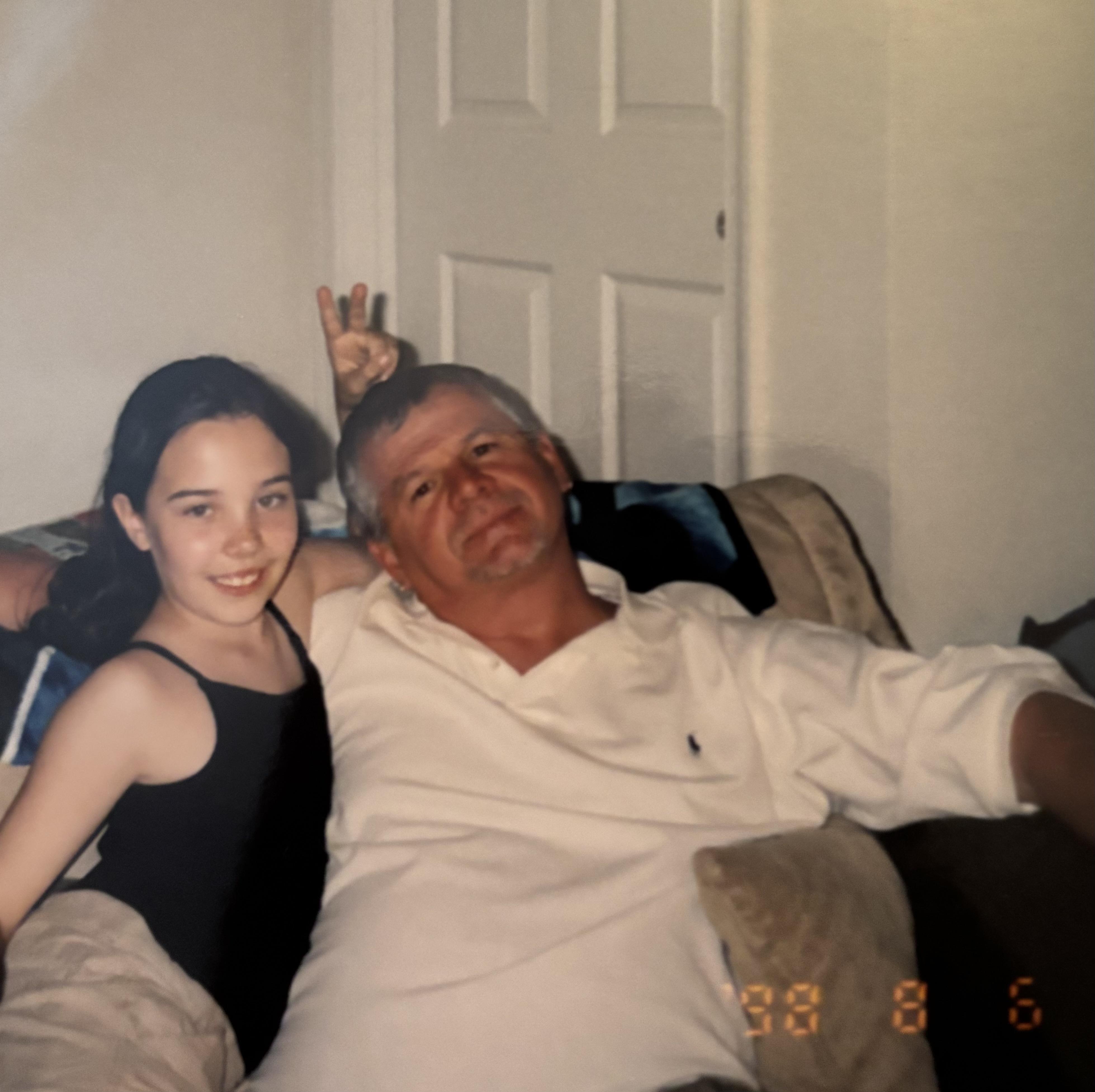 A man and a girl posing for a picture