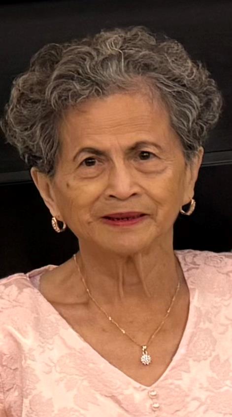 A woman with grey hair wearing earrings