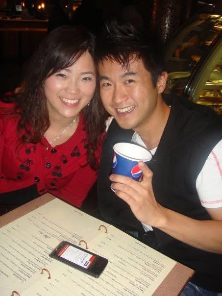 A man and woman smiling at a table