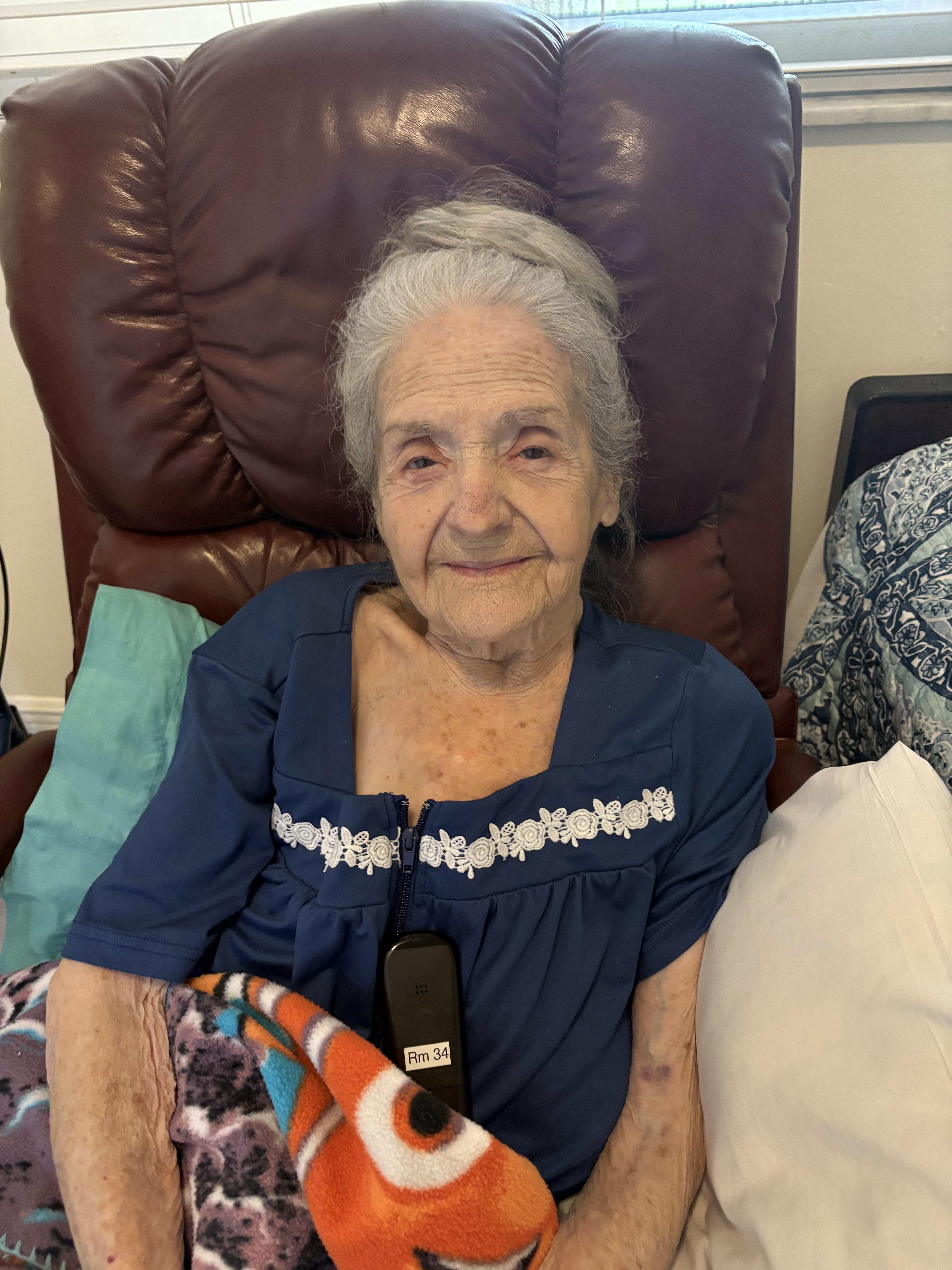 An old woman sitting in a chair