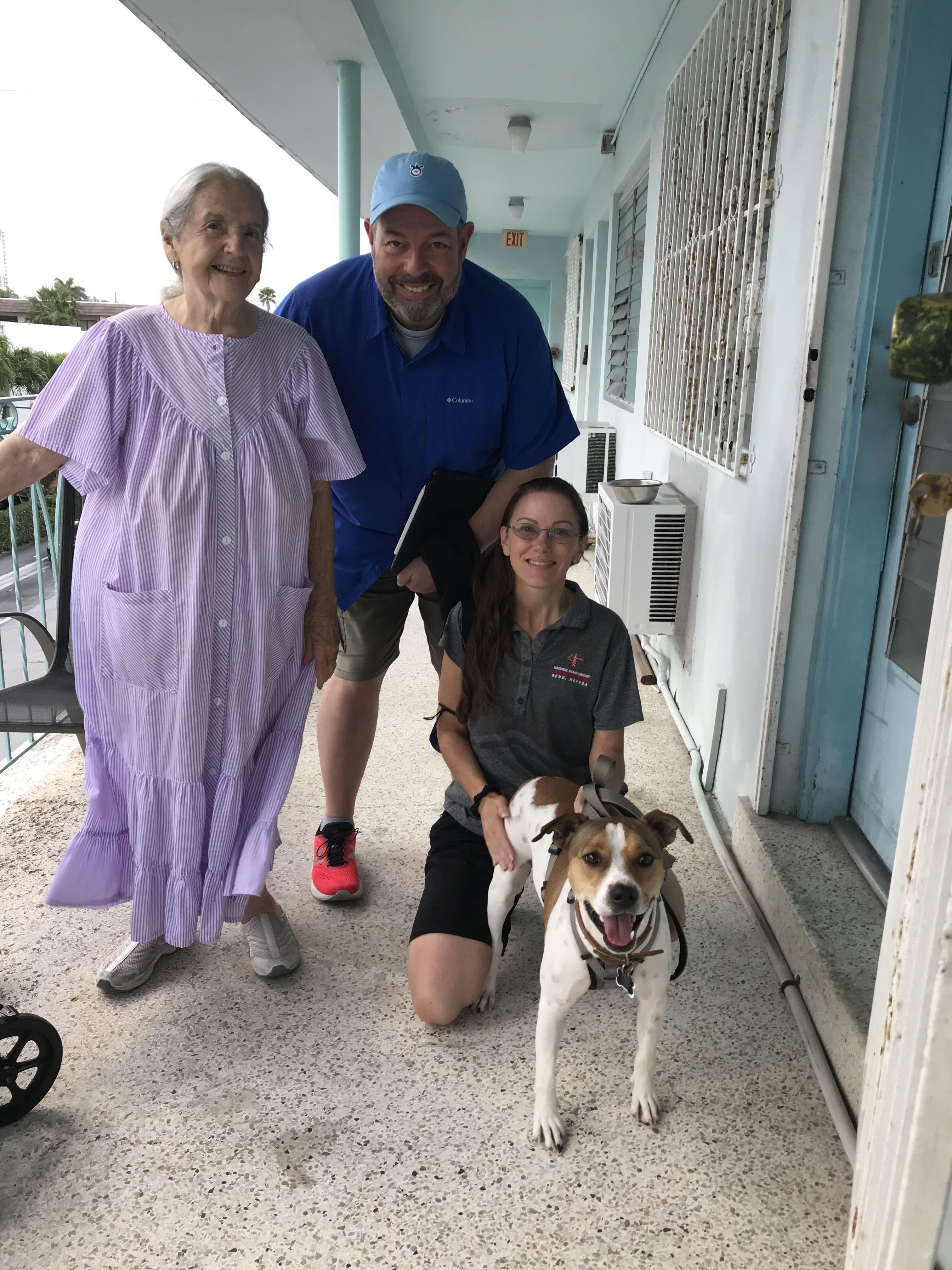 A man and woman with a dog