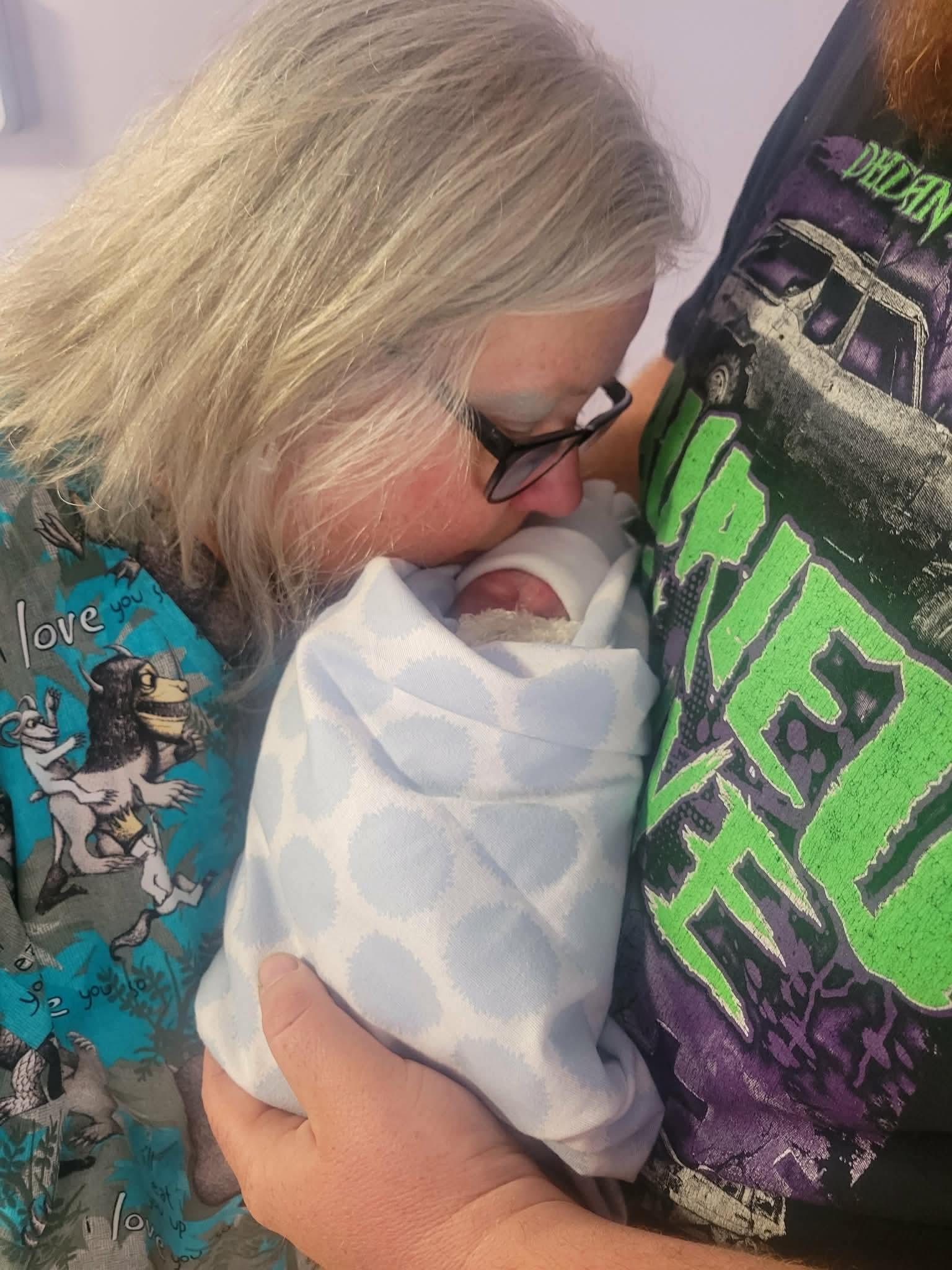 A woman kissing a baby