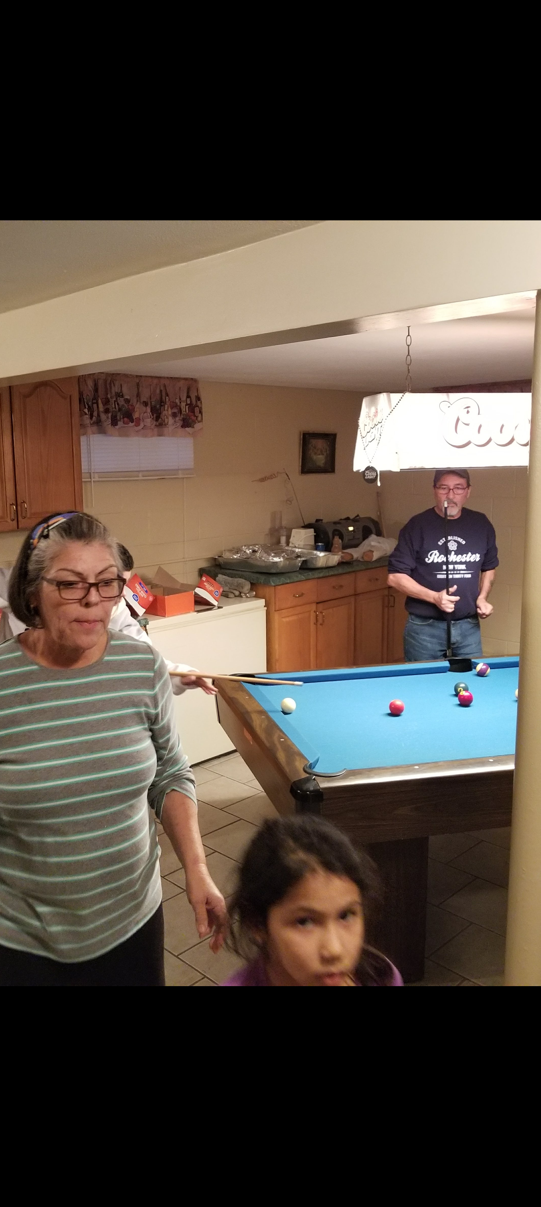 A group of people playing pool