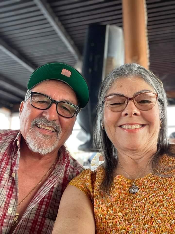 A man and woman smiling for a selfie