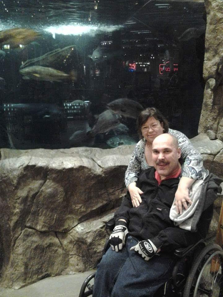 A man and woman in a wheelchair