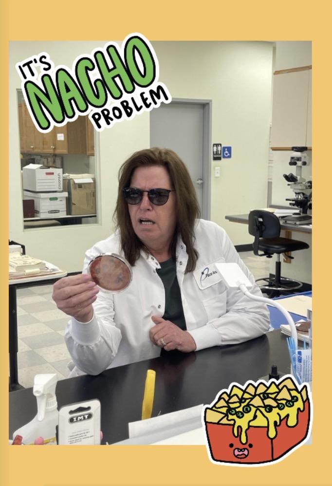 A woman wearing sunglasses and holding a round object