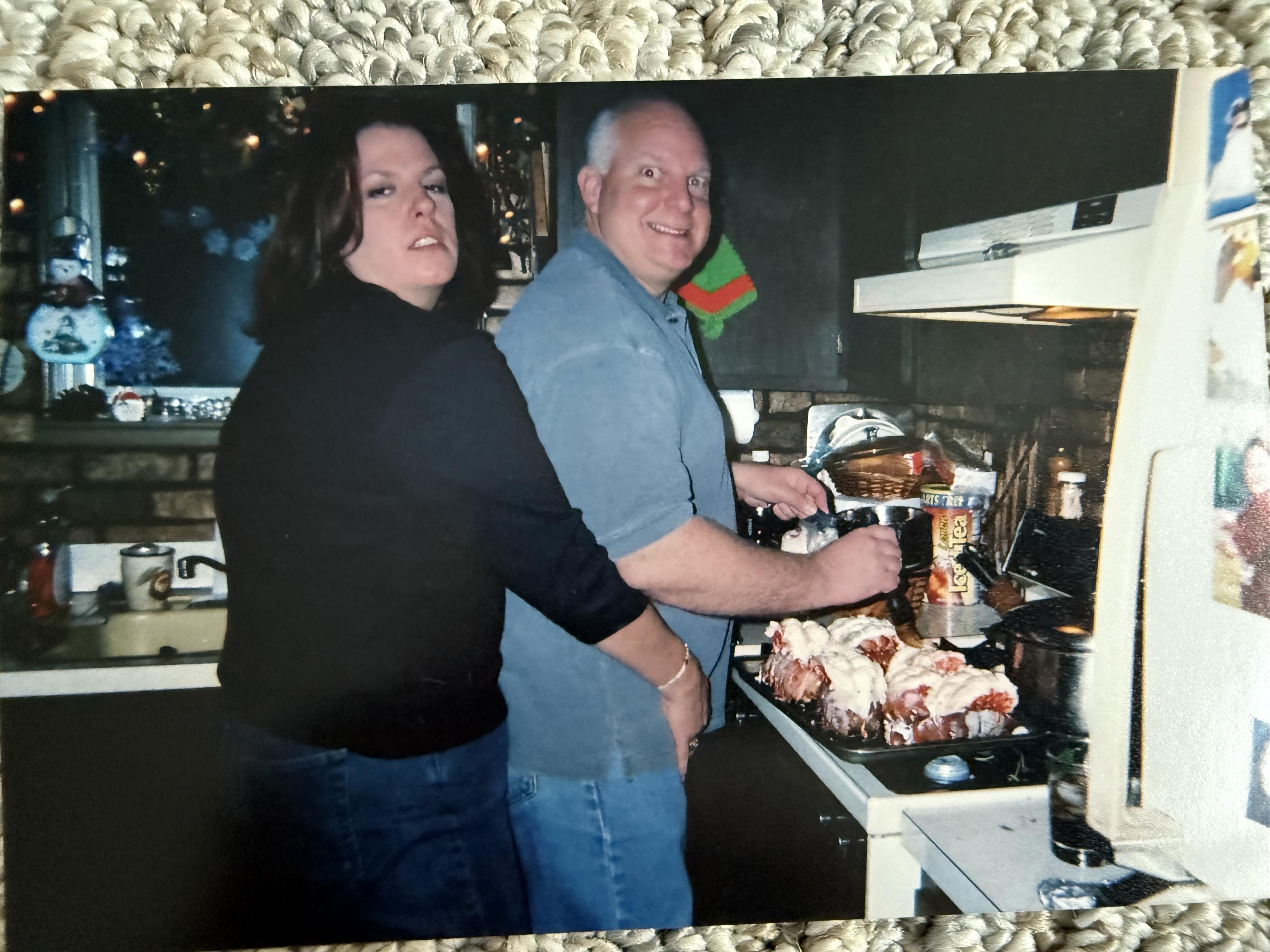 A man and woman standing in a kitchen