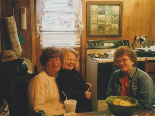 A group of women sitting in a kitchen