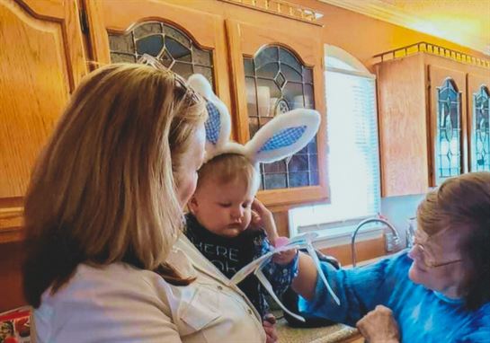A woman and a baby in a kitchen