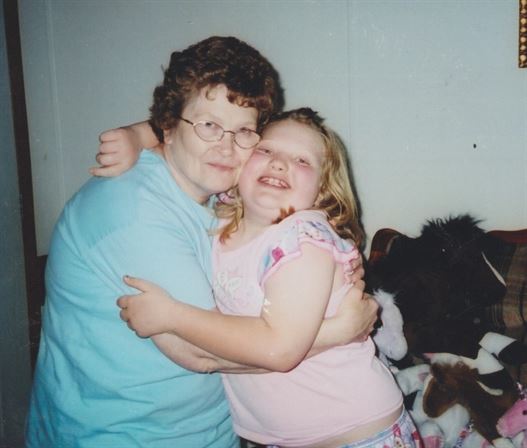 A woman and a girl hugging
