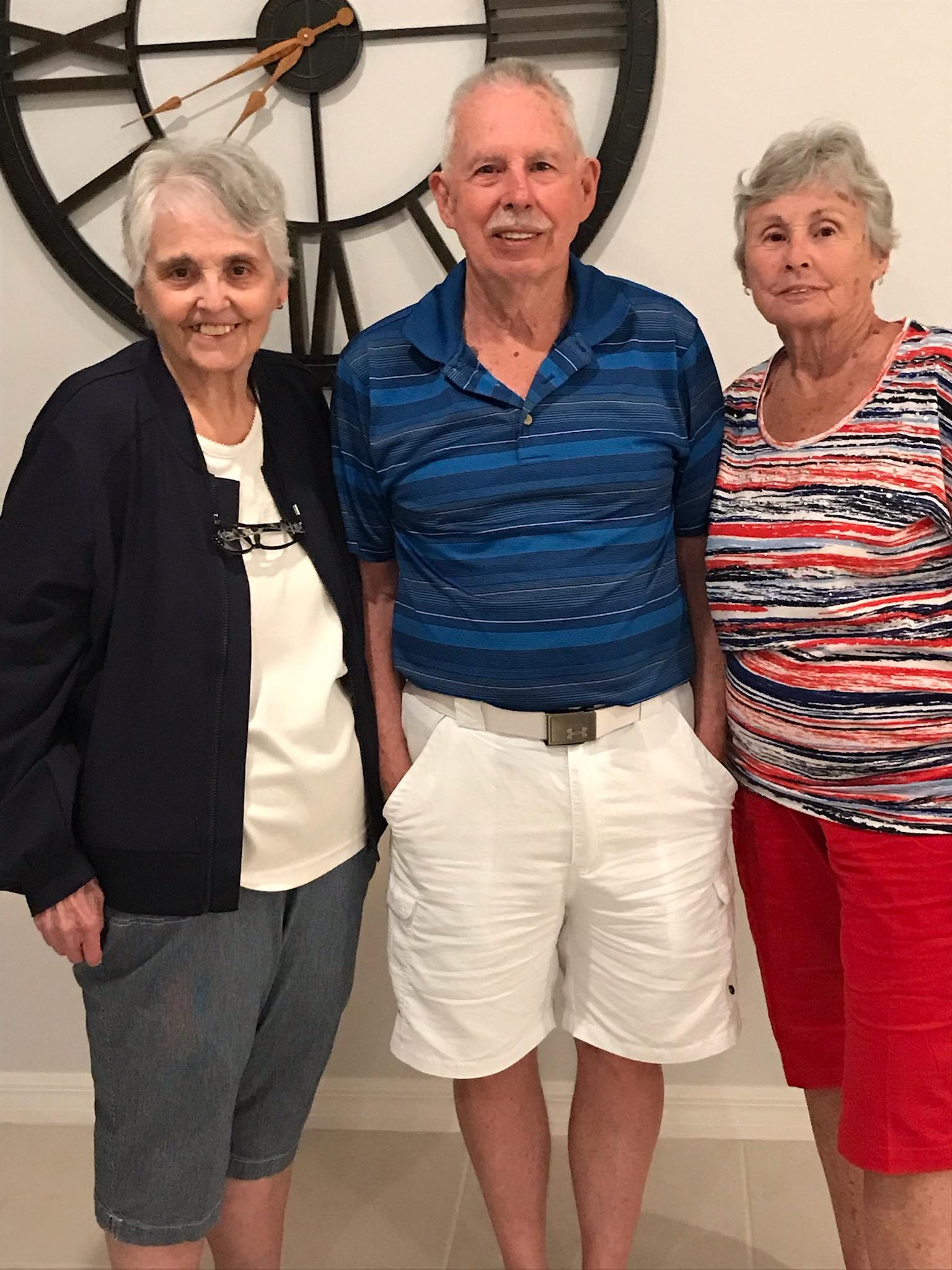A group of people standing in front of a clock