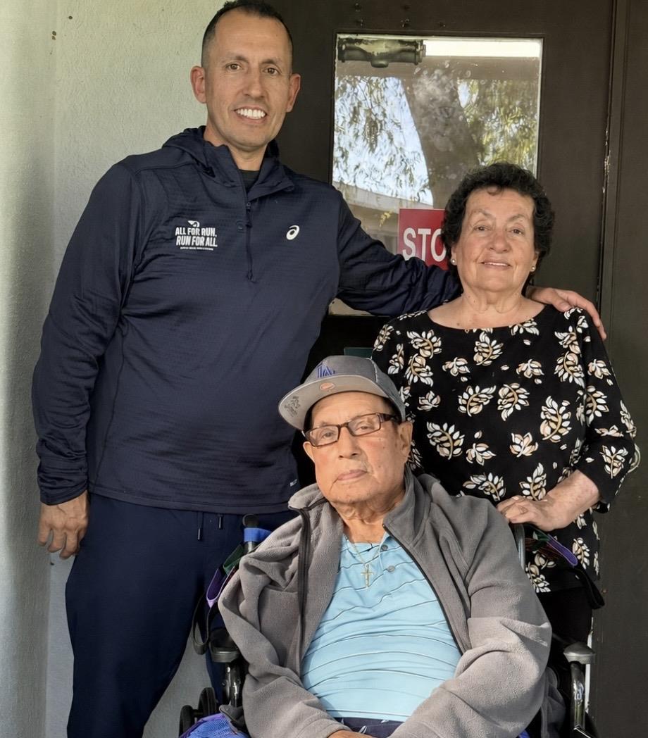 A man in a wheelchair with a woman in a doorway