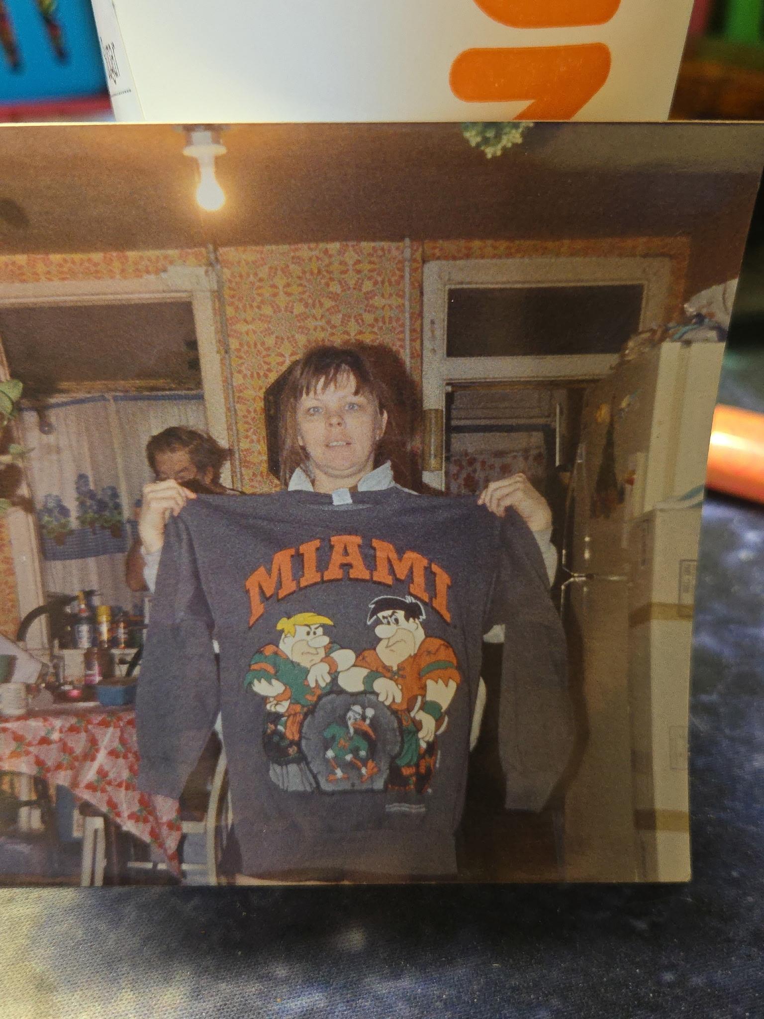 A woman holding a sweatshirt