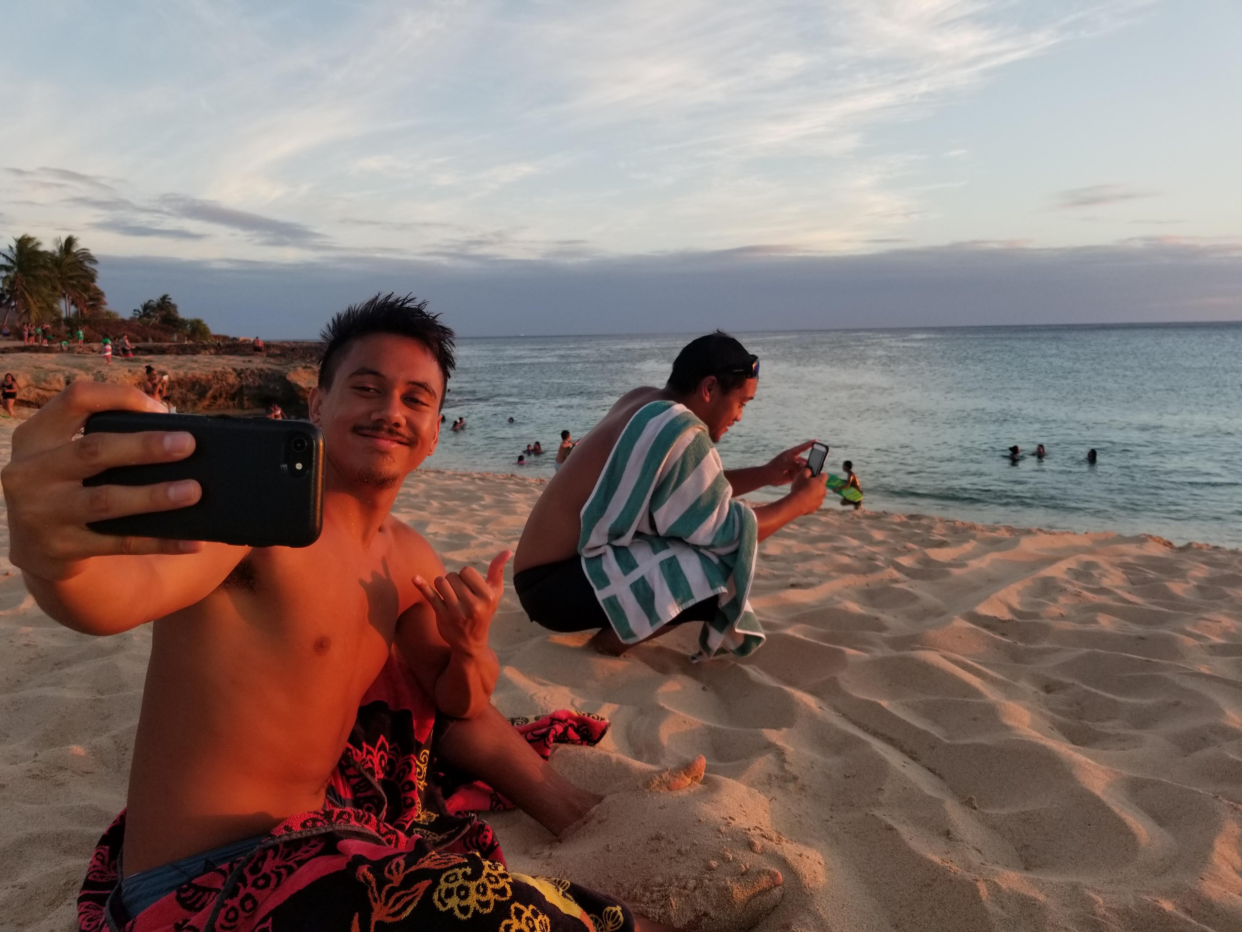 A man taking a selfie on a beach