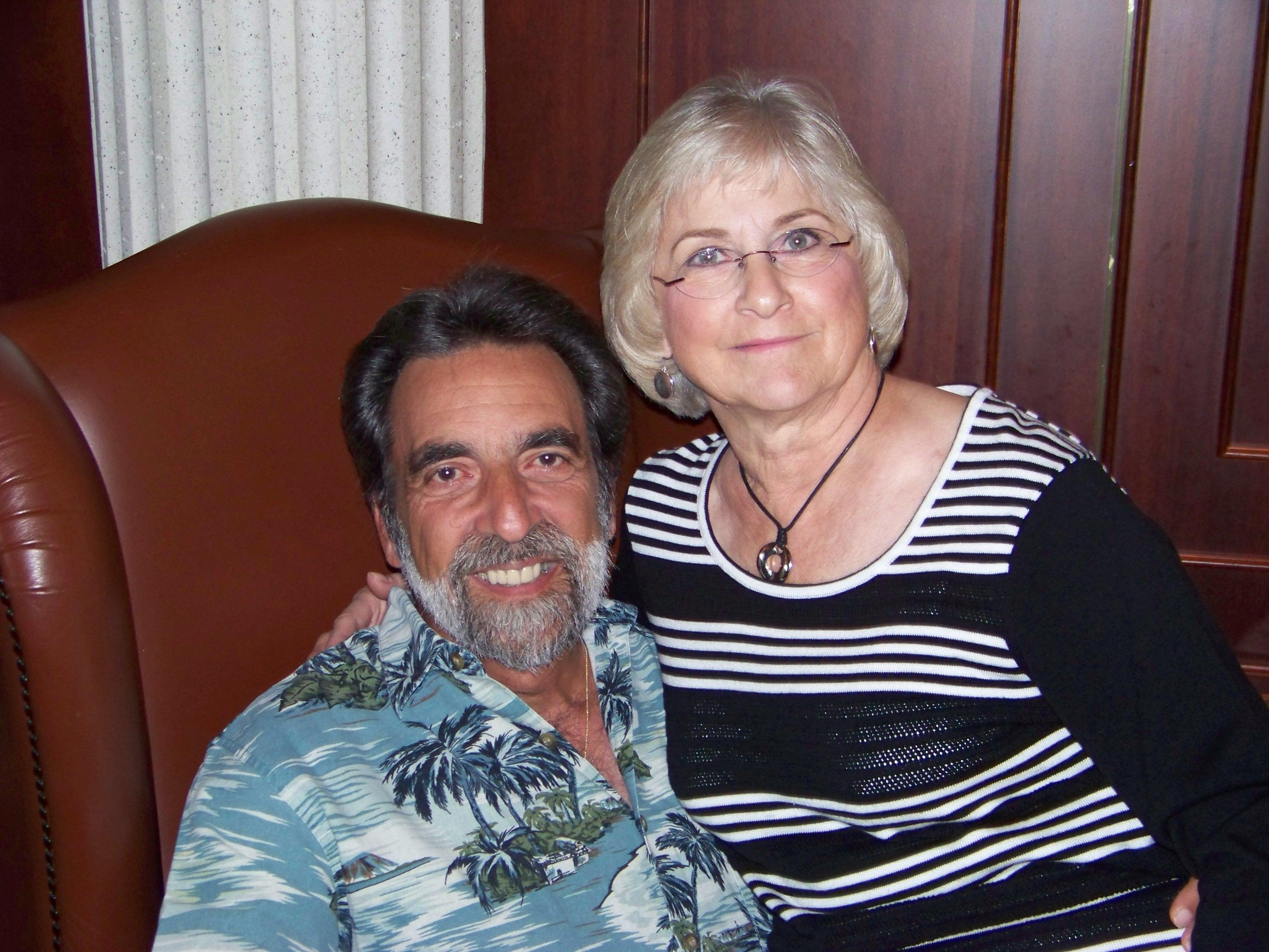 A man and woman sitting in a chair
