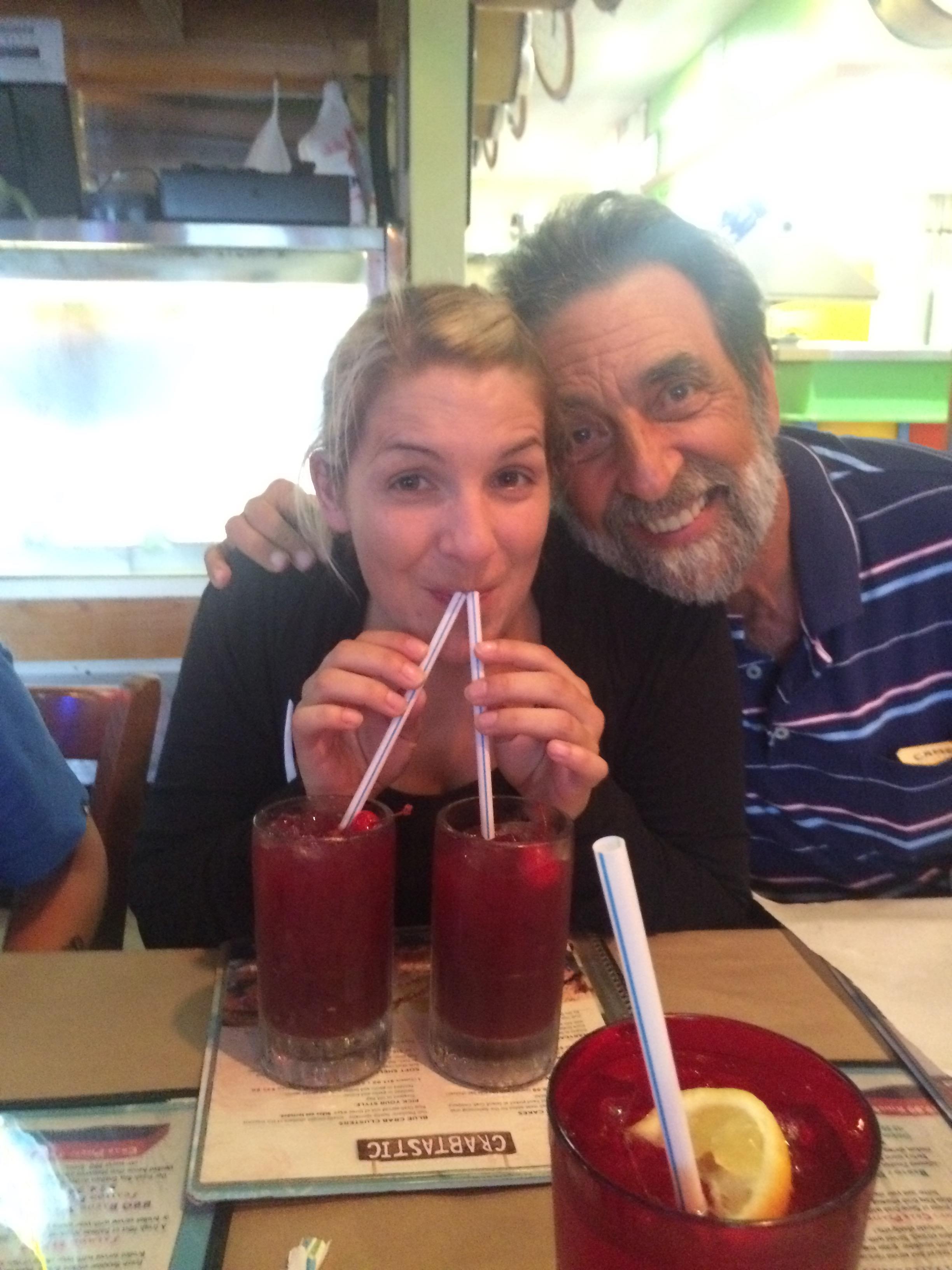 A man and woman drinking from straws