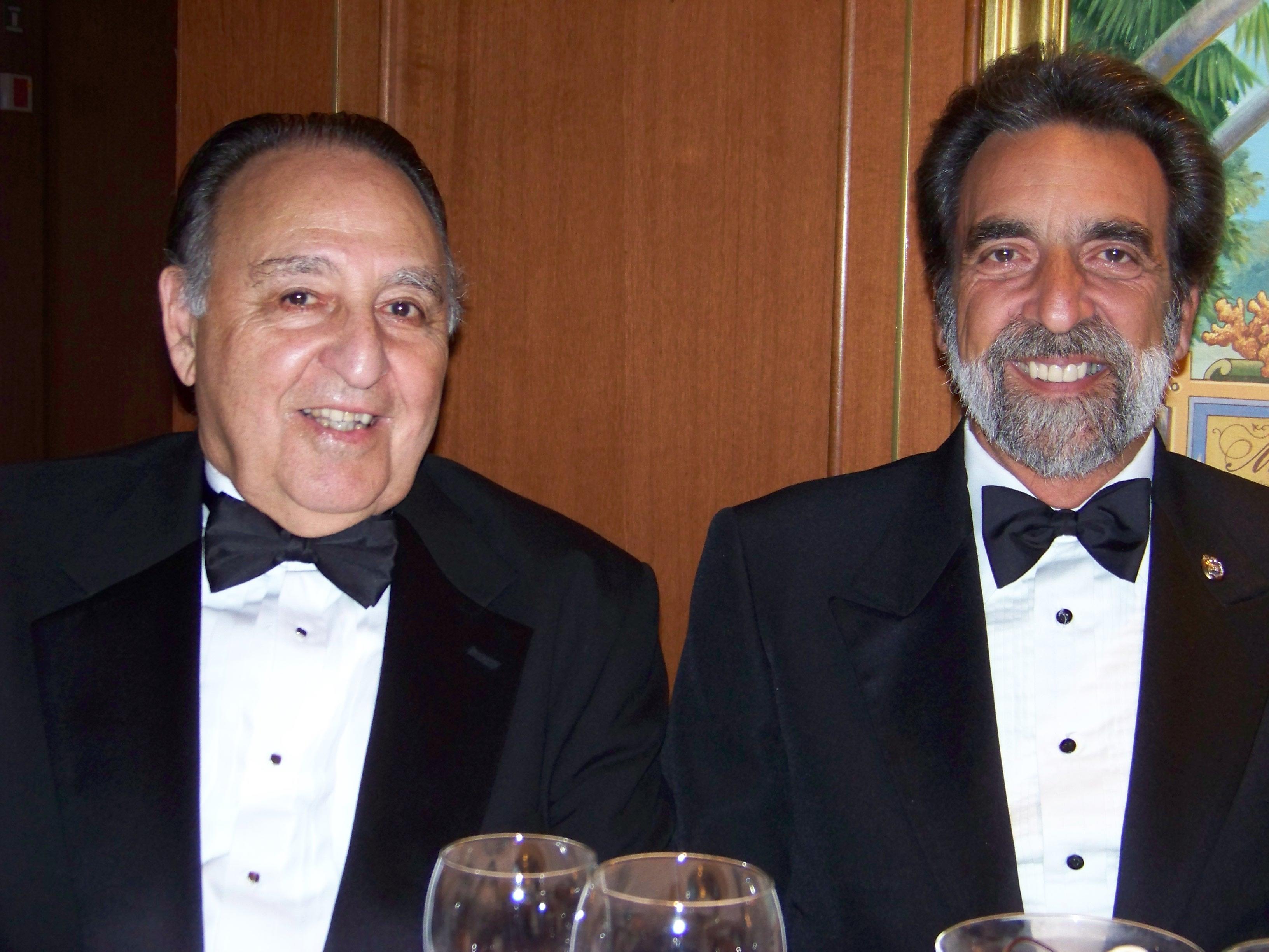 Two men in suits smiling at camera
