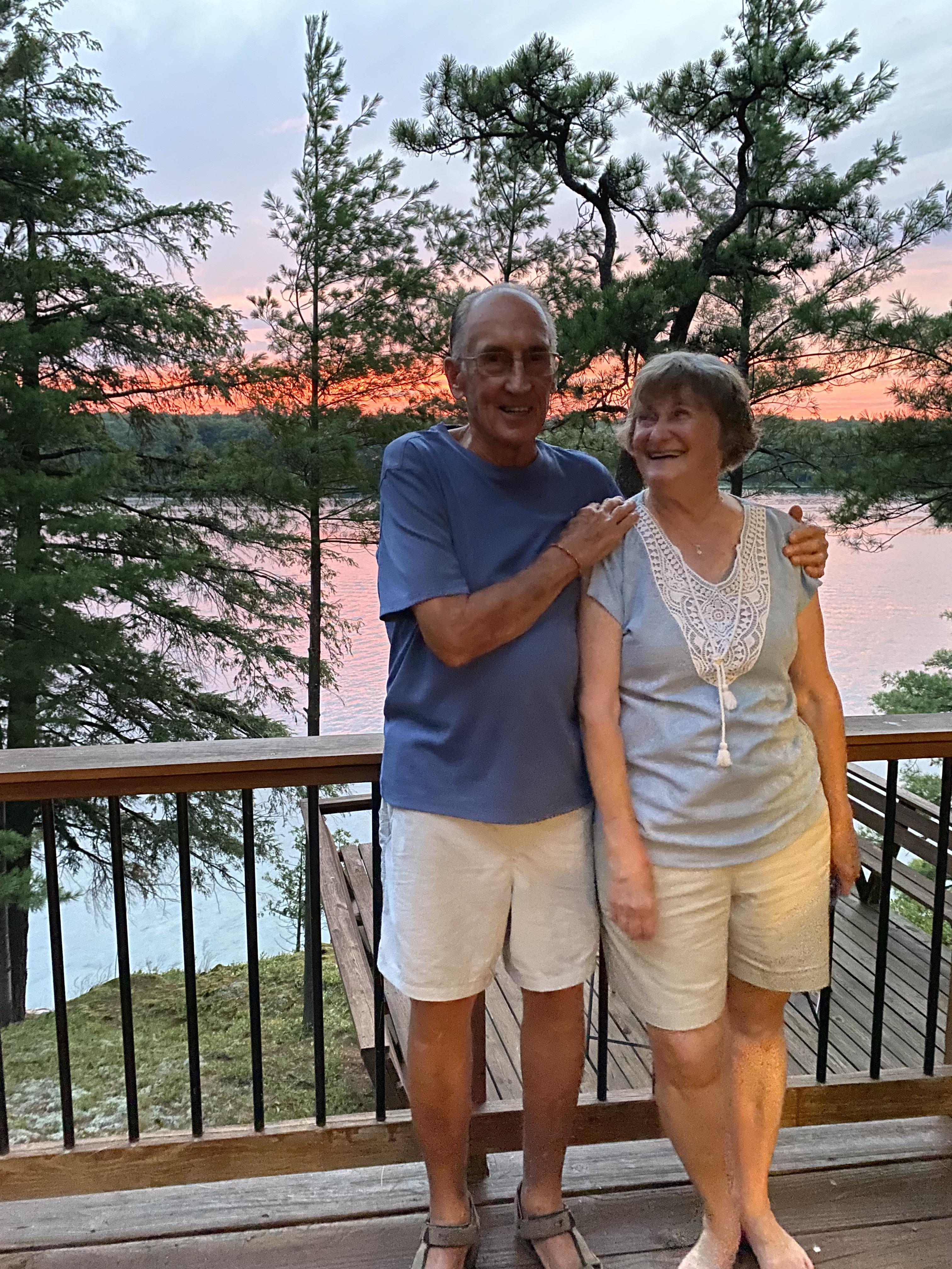 A man and woman standing on a deck