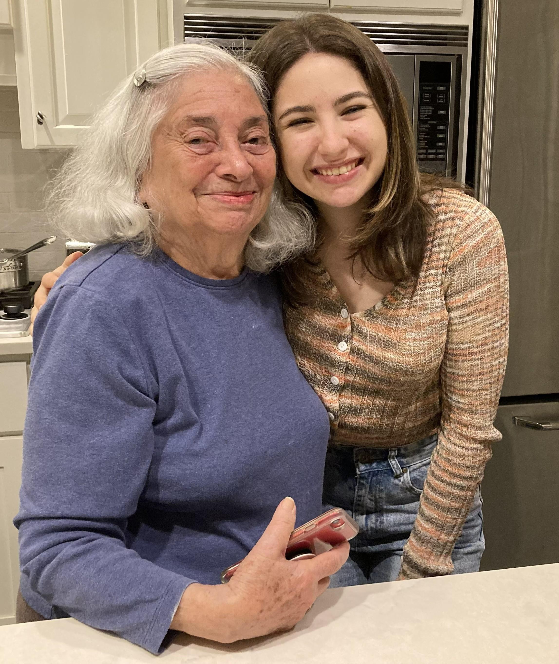 A woman and a young woman posing for a picture