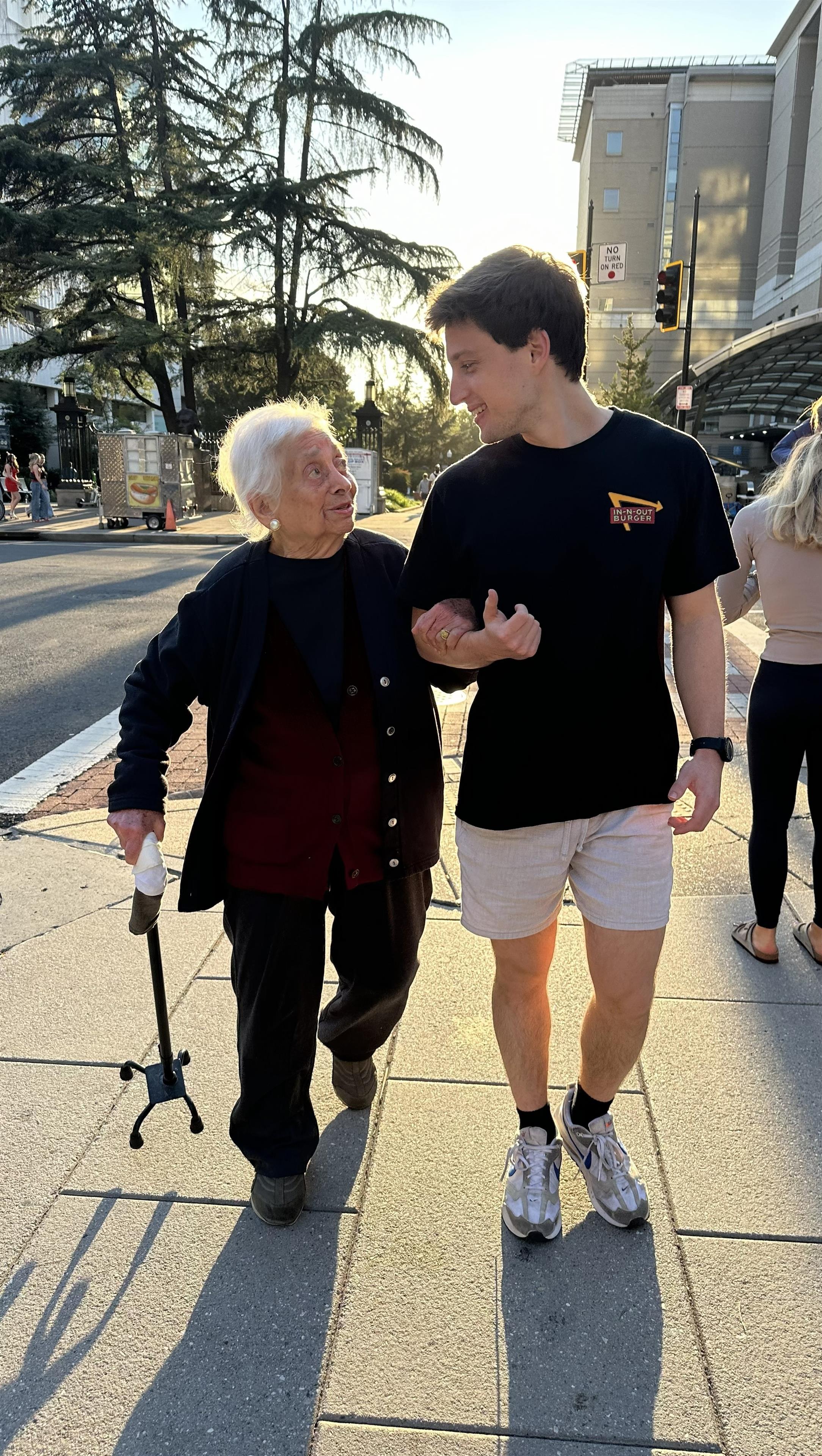 A man and woman walking on a sidewalk