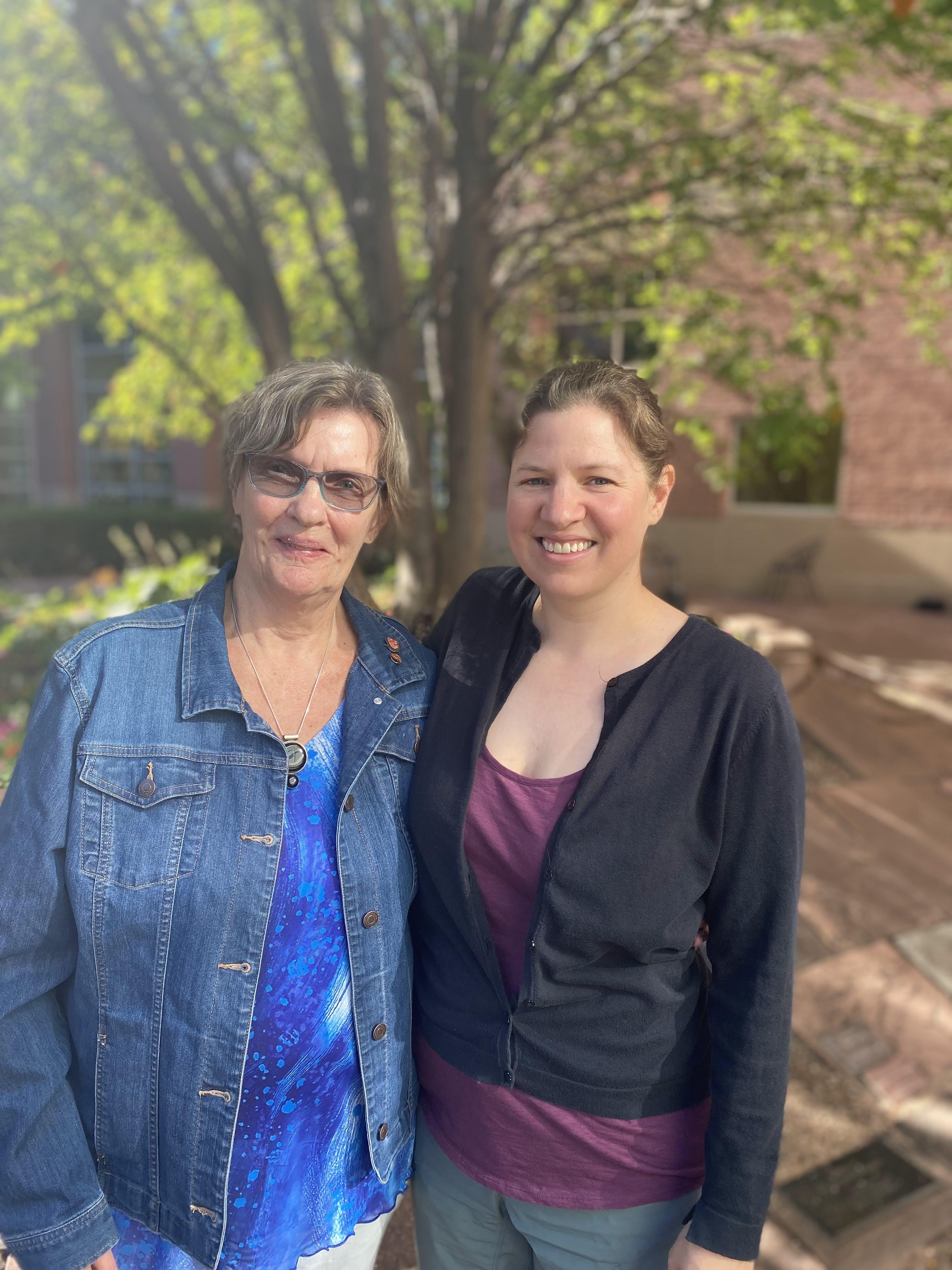 Two women standing next to each other