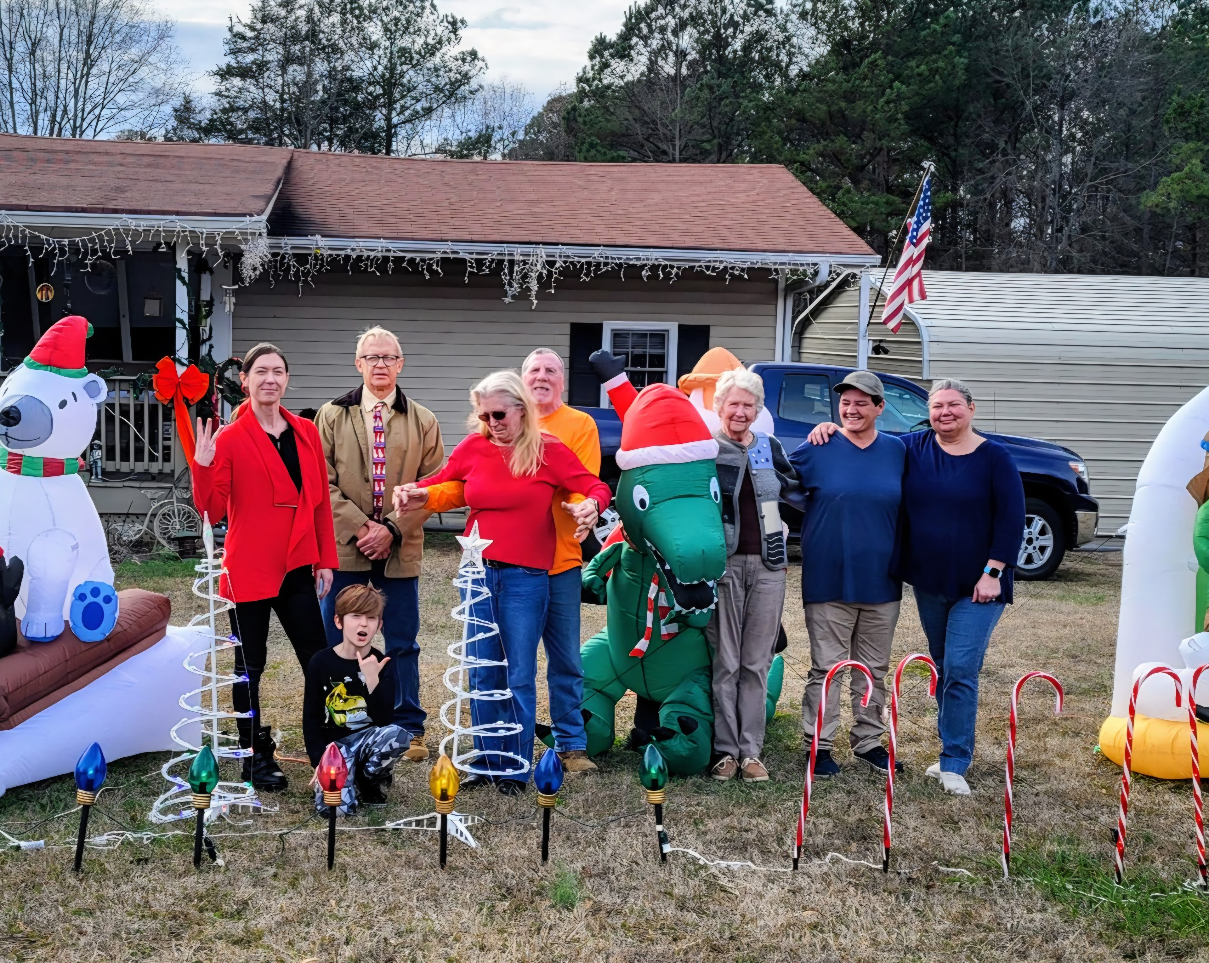 A group of people standing in front of a house