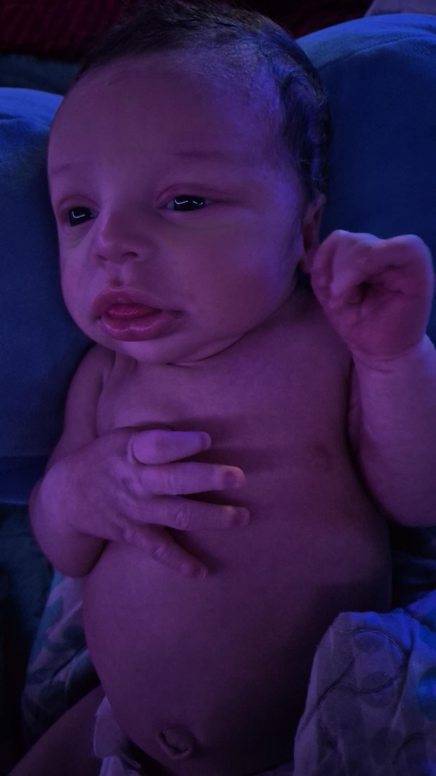 A baby with a purple light