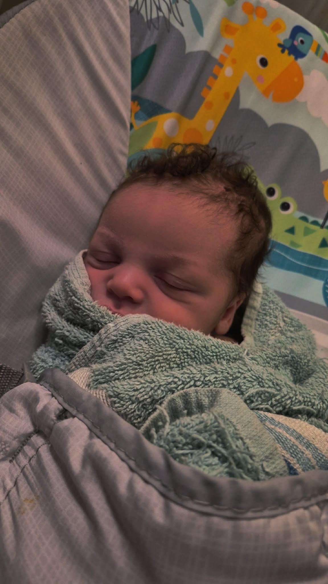 A baby wrapped in a blanket