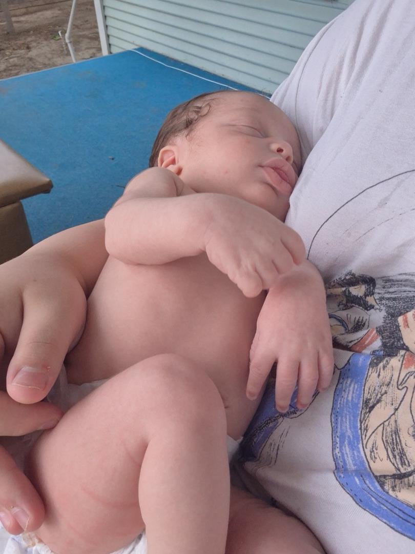 A baby sleeping in a person's lap