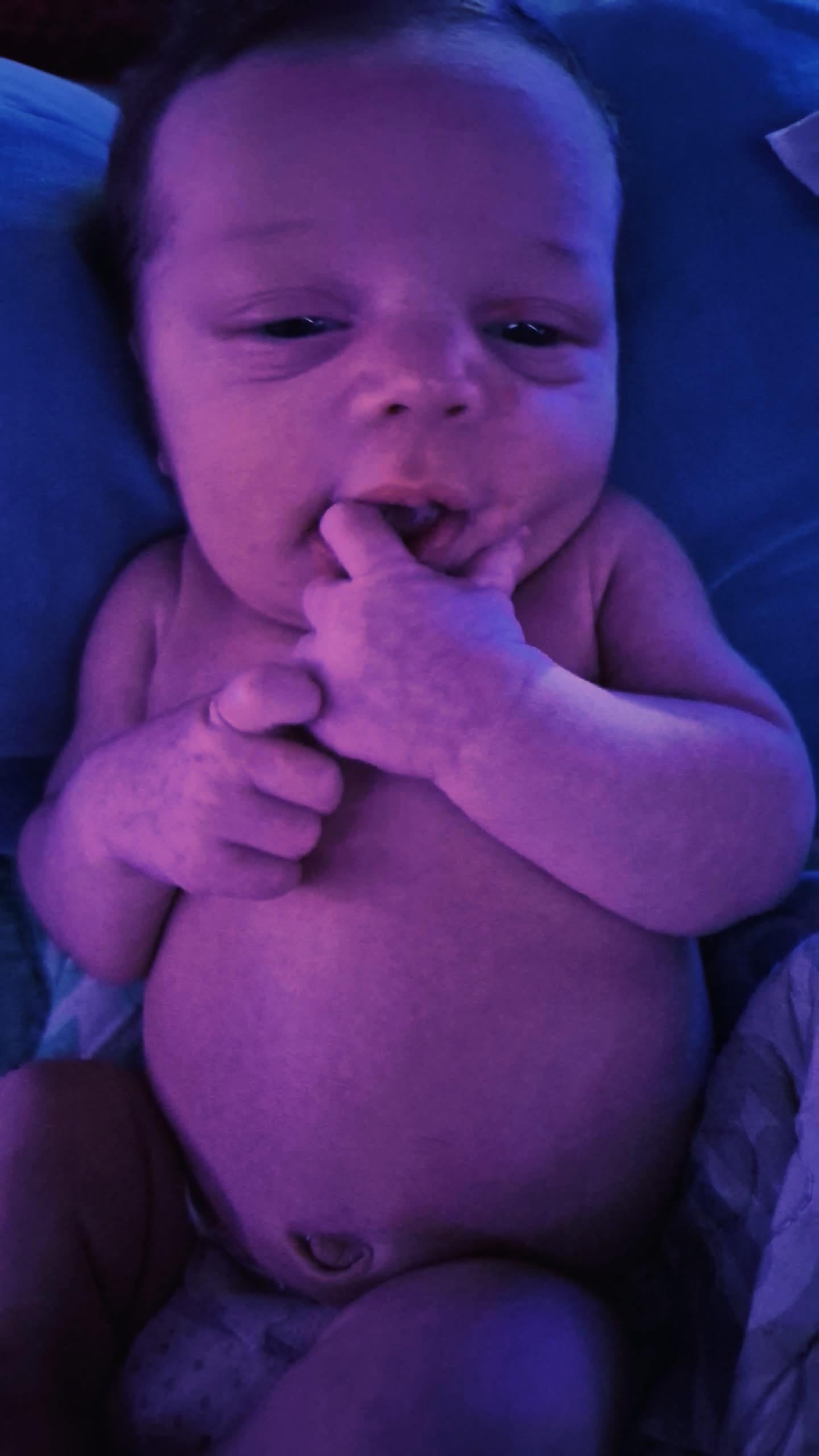 A baby with fingers in mouth