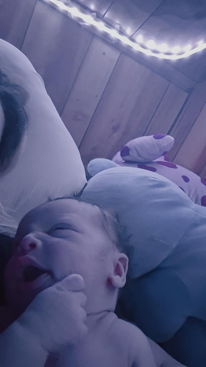 A baby lying on a bed