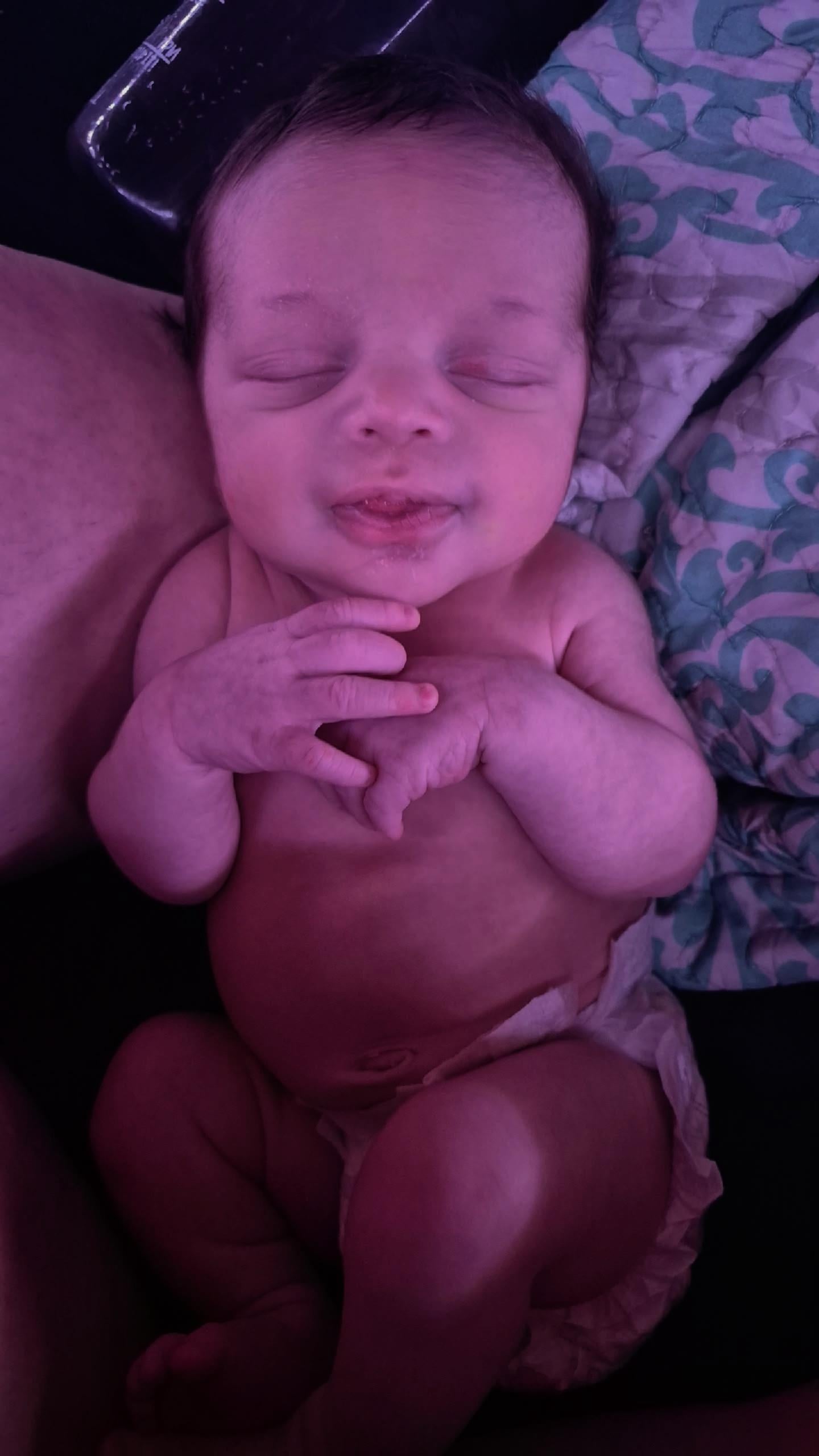 A baby sleeping on a blanket