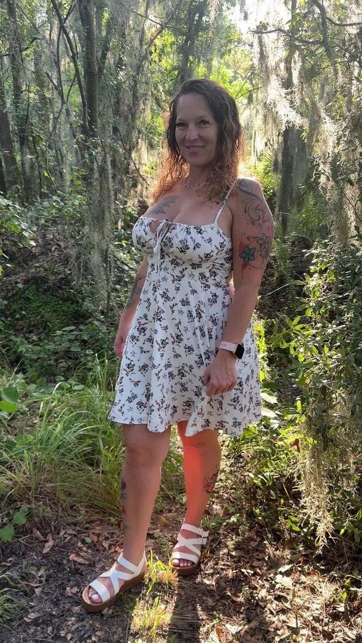A woman in a dress in the woods